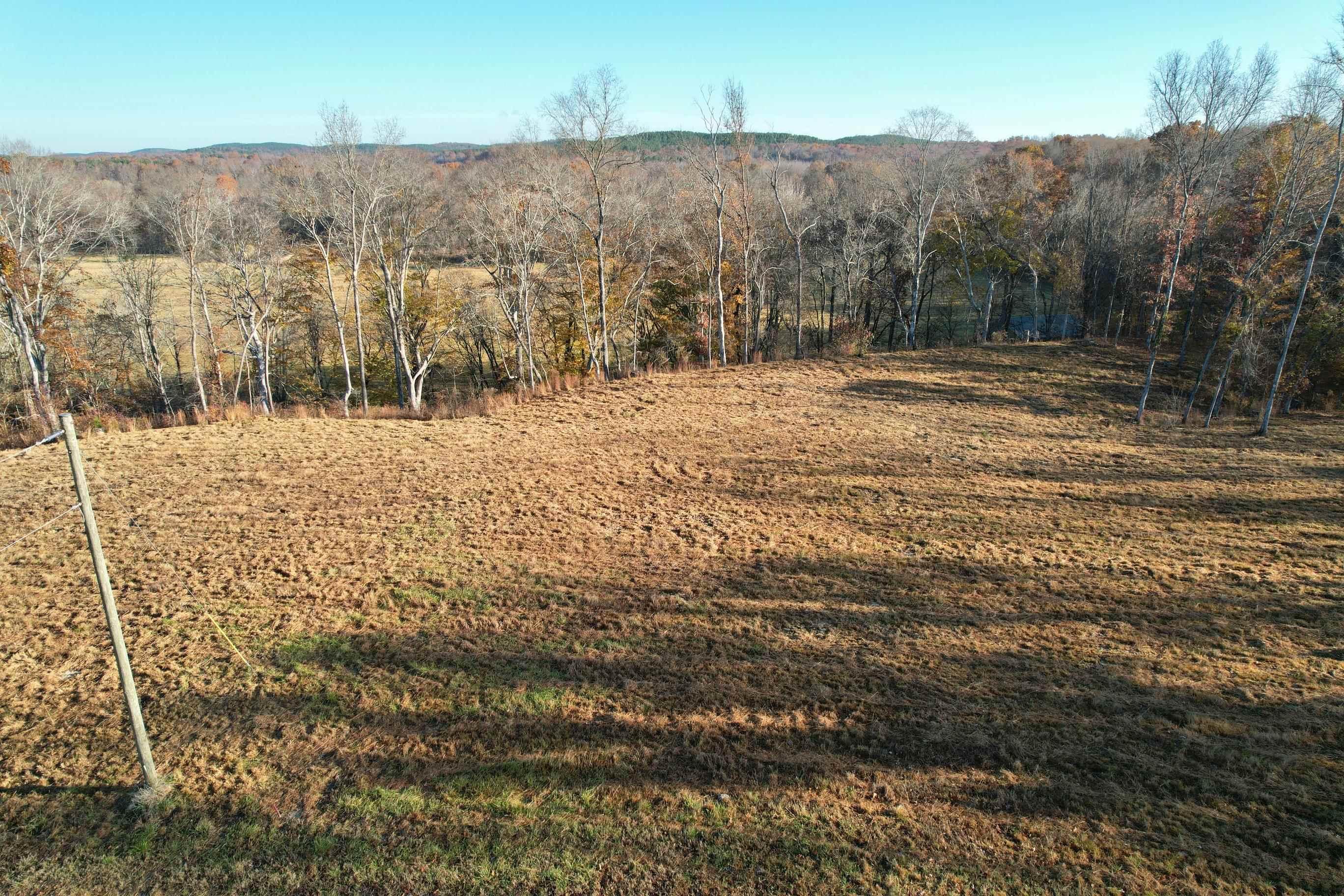 Image 4: View of mountain background with a heavily wooded area