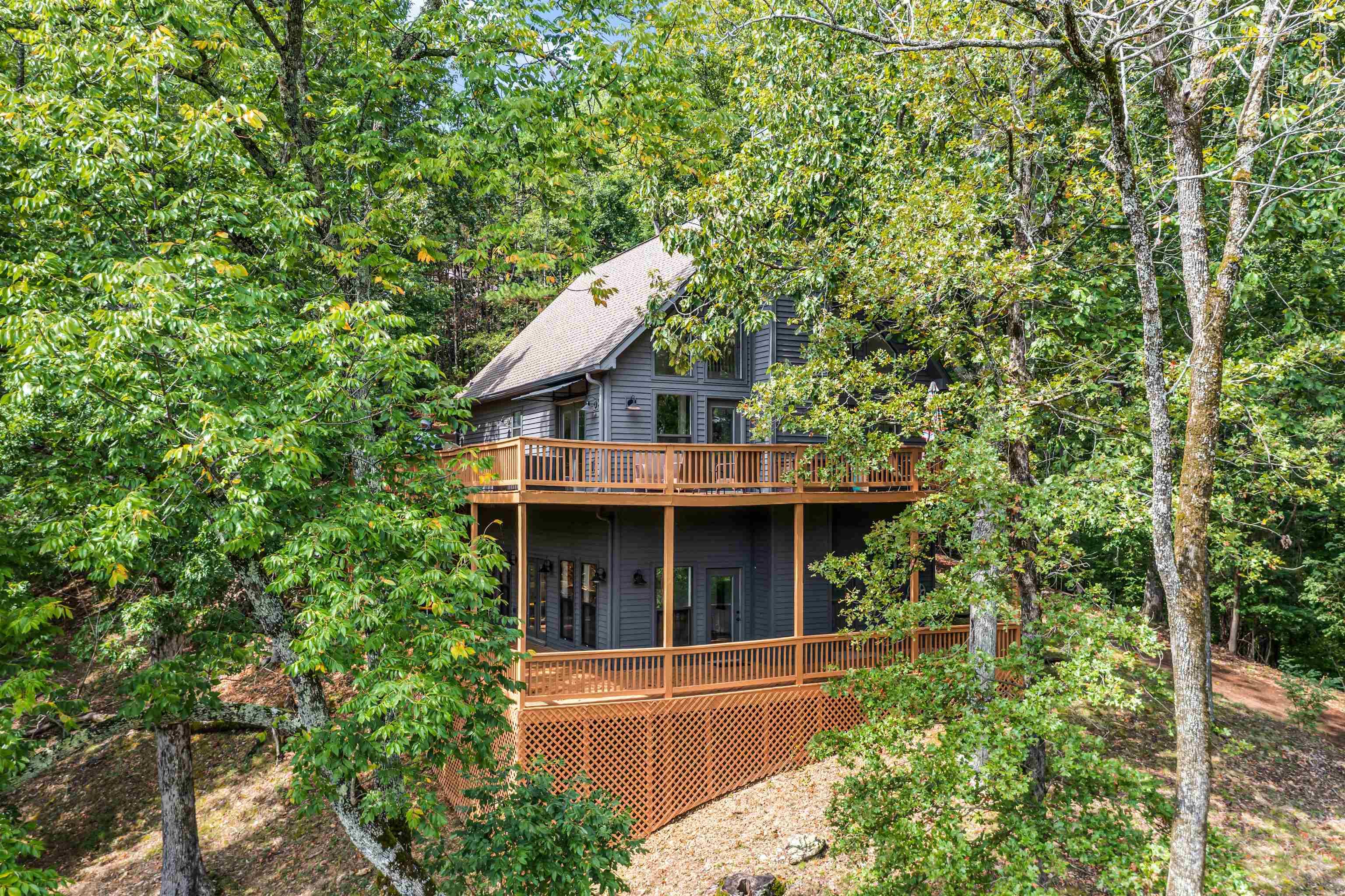 Image 2: Front view of home featuring 2 story porches that overlook year round water views.