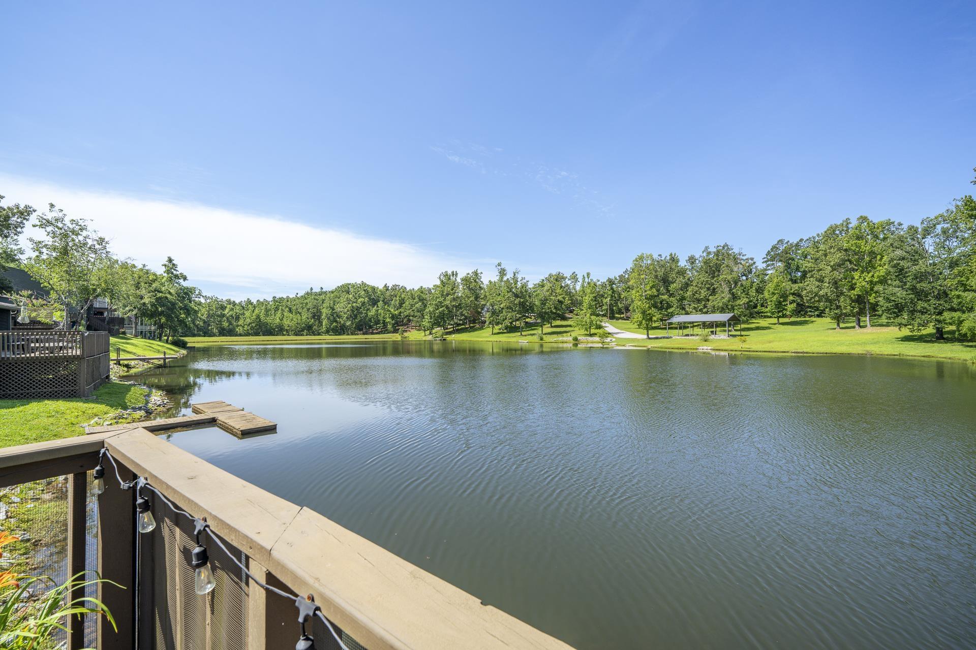 Image 1: Lakeside property featuring a spacious deck with string lighting view is from the lower deck