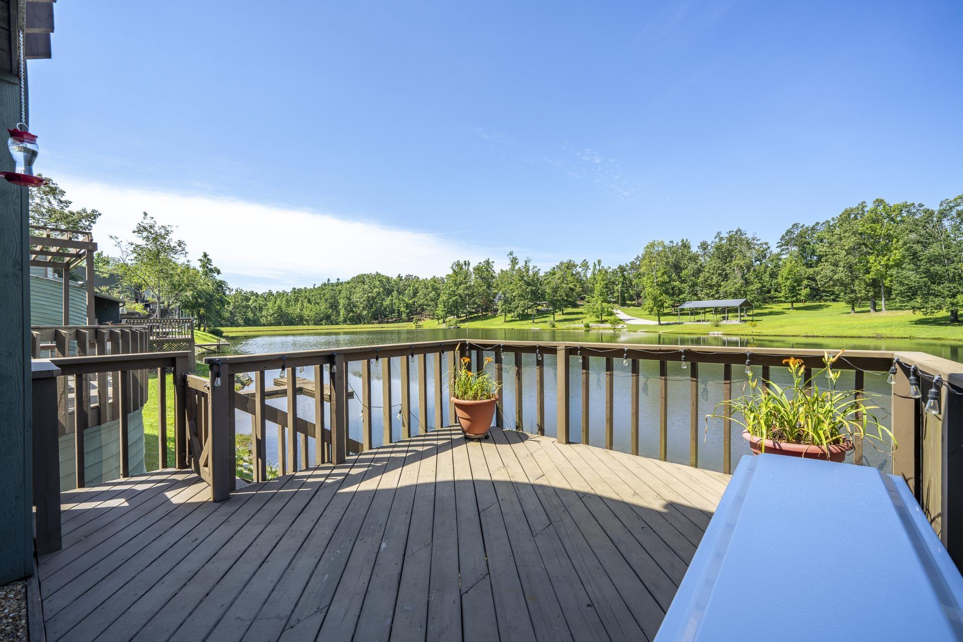 Image 3: Expansive outdoor deck featuring wood-finish flooring and a full railing. Deck is off the living area
