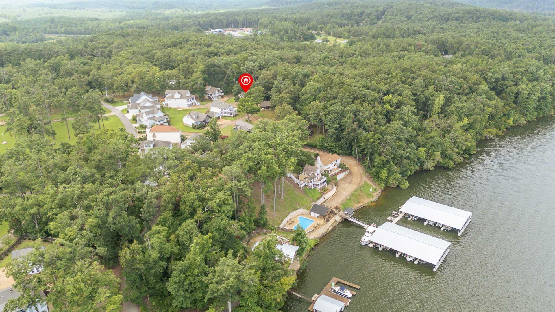 Image 4: Expansive aerial perspective showcasing a residential community nestled among mature trees on Pickwick Lake