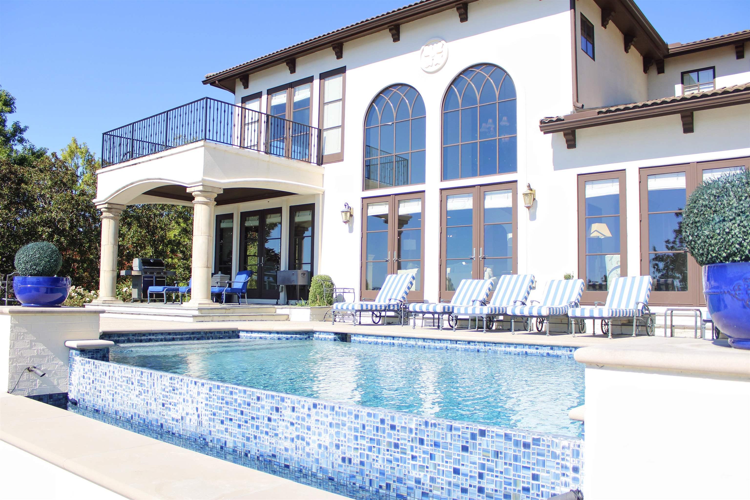 Image 3: View of swimming pool with a patio area, an infinity pool, and area for grilling