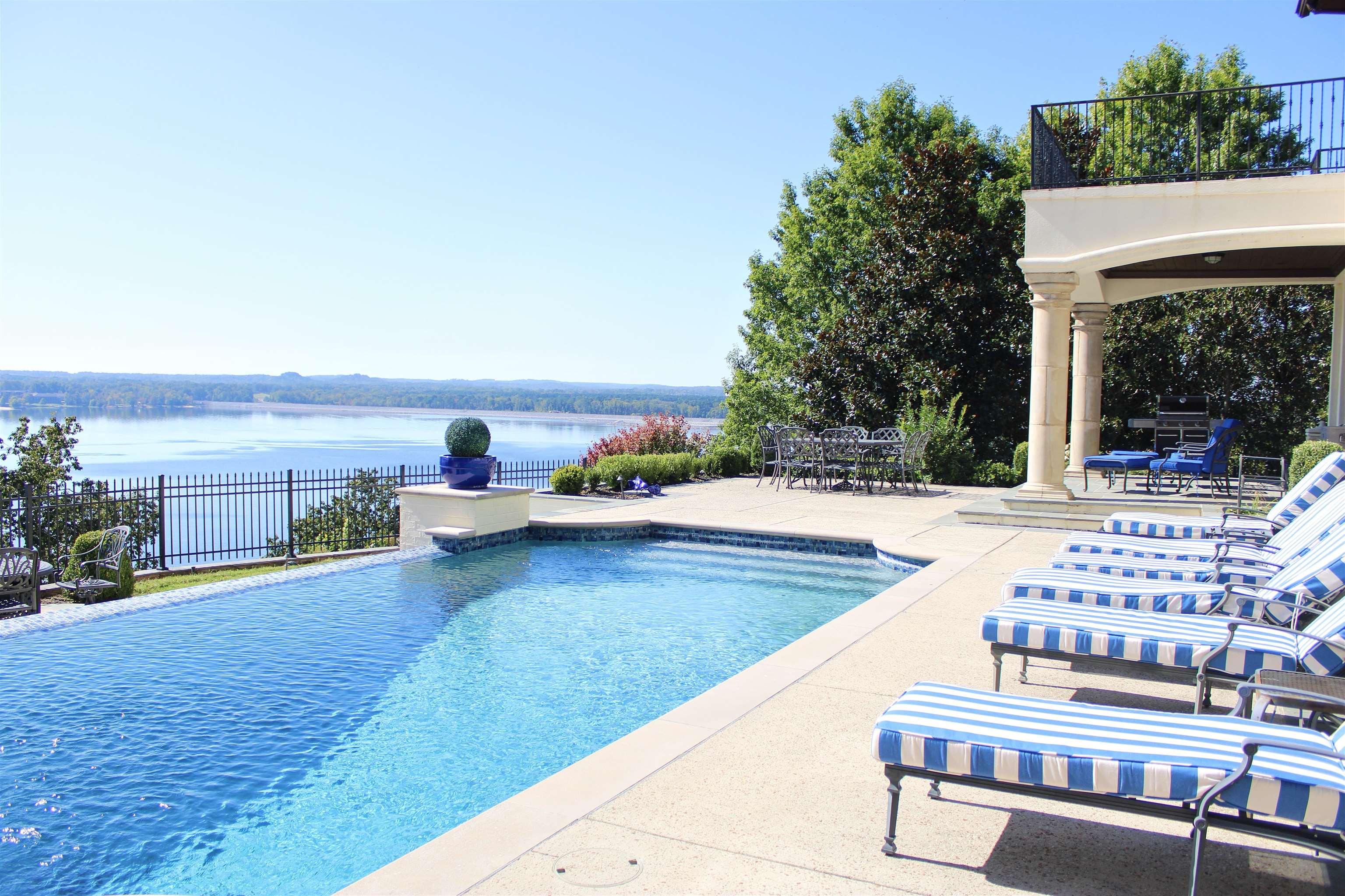 Image 4: Swimming pool featuring a patio area, outdoor dining area, and a water view
