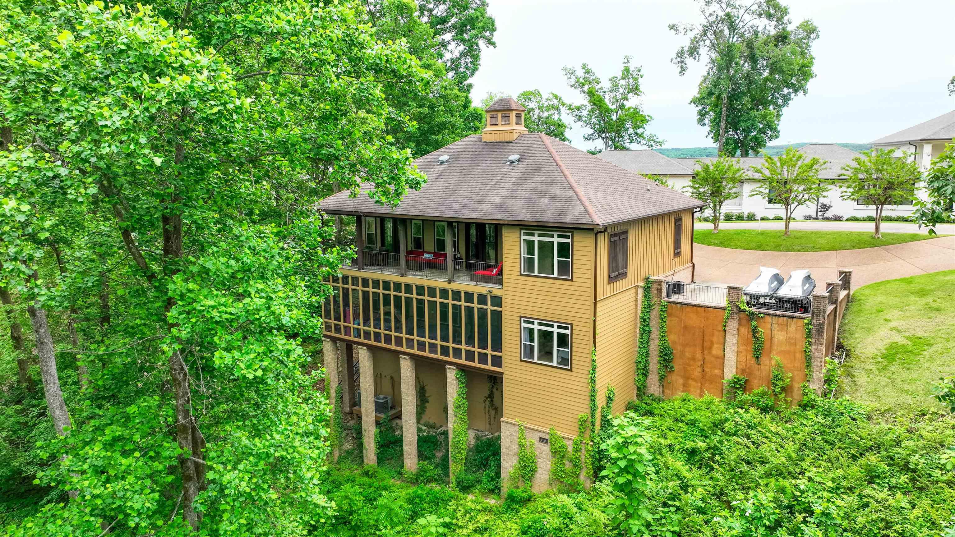 Image 3: Elevated residence featuring a cupola, multi-level screened porch, and a private upper-level balcony