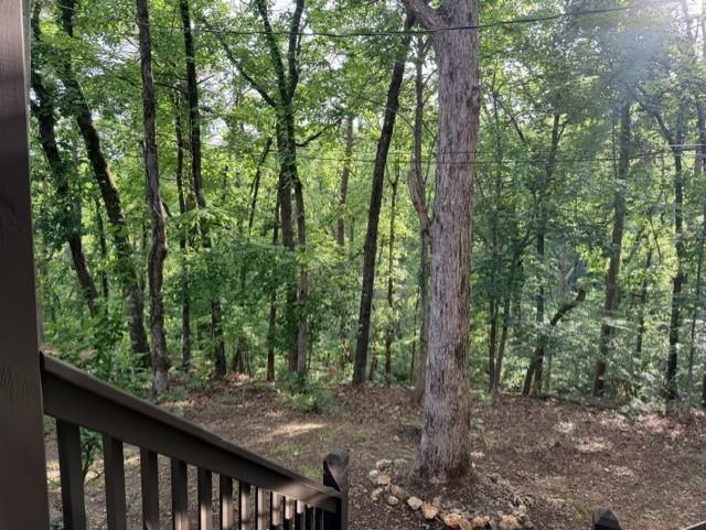 Image 4: Wooded grounds featuring mature trees and natural landscaping