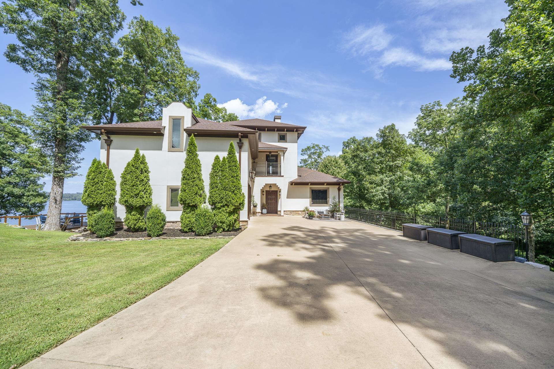 Image 1: Mediterranean-inspired residence featuring a stucco exterior and a terracotta tile roof