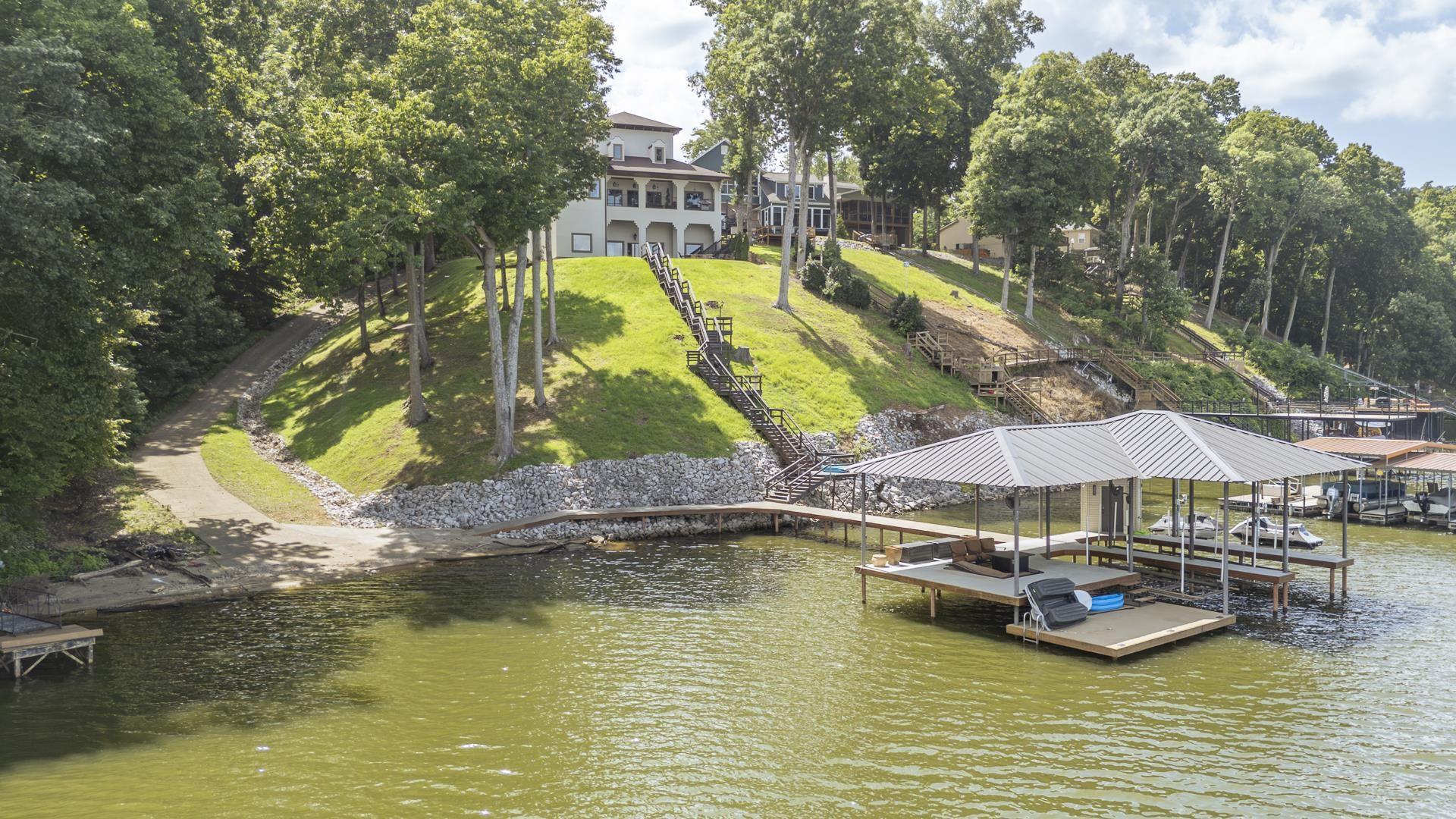 Image 3: Covered boat dock with multiple slips, wooden decking, and direct water access