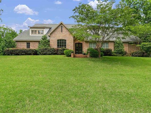 Image 1: View of front of house featuring a front lawn, brick siding, and french doors