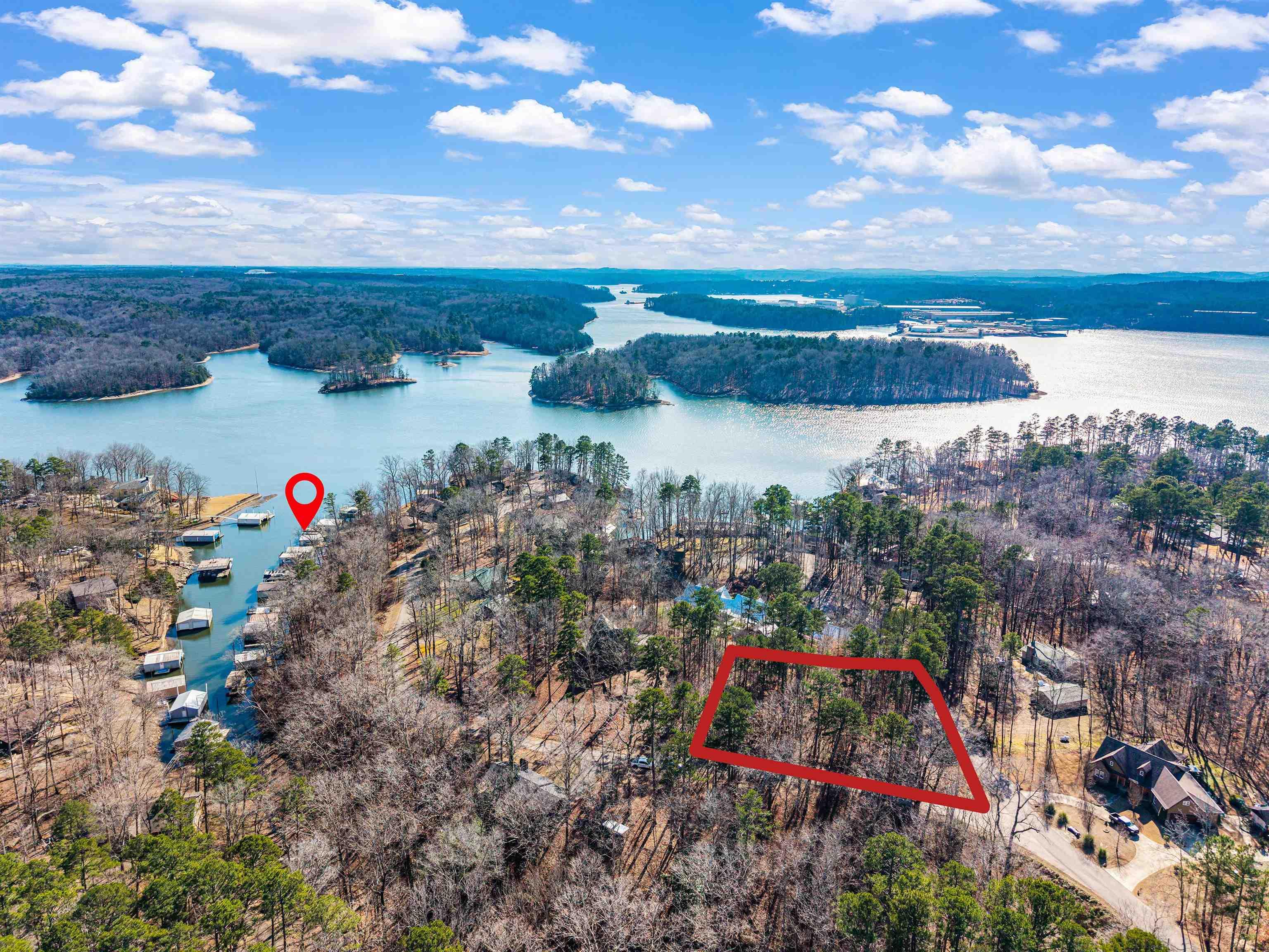 Image 2: Aerial view of property and surrounding area featuring property parcel outlined and a nearby body of water