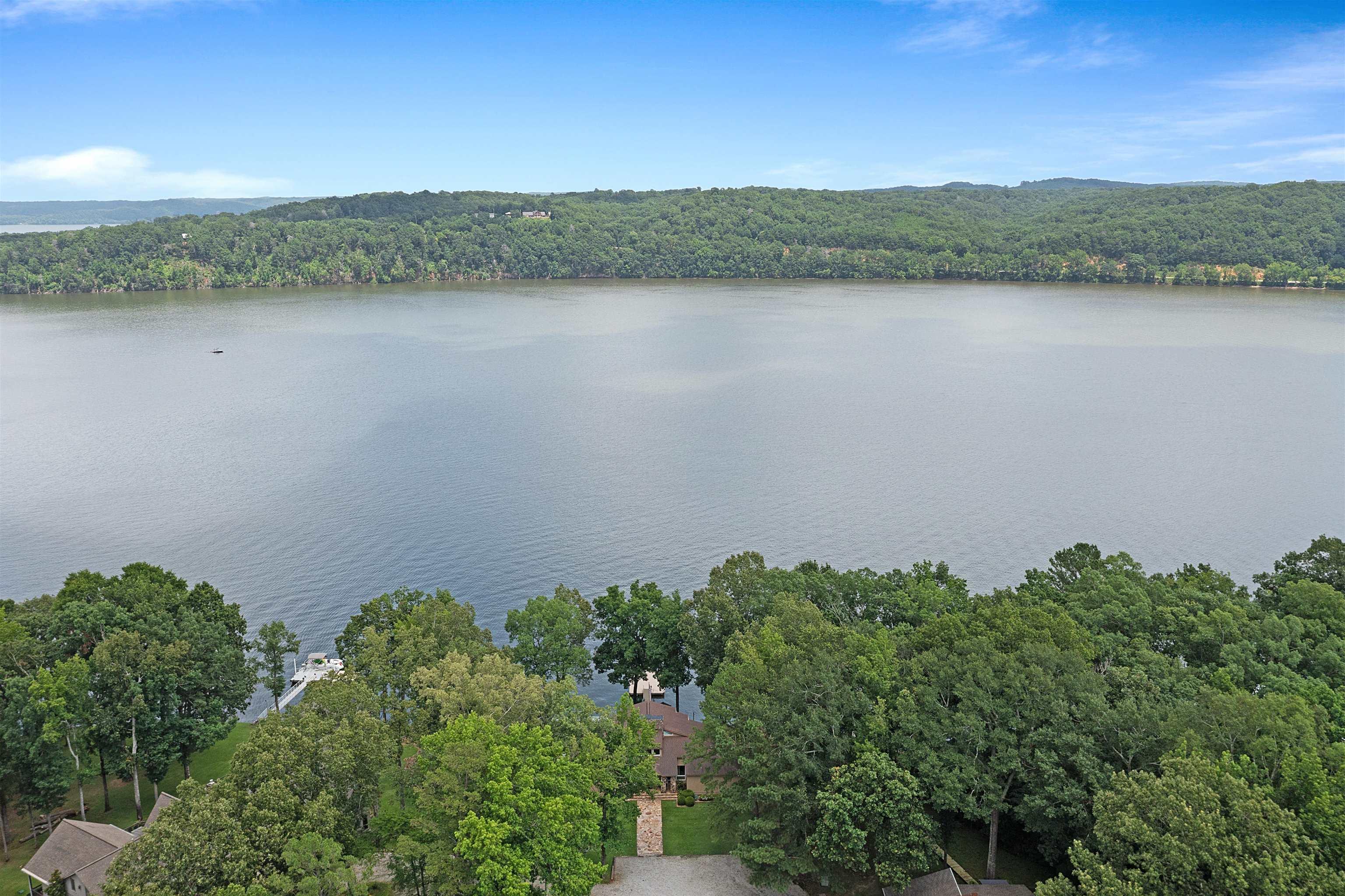 Image 3: Water view with a heavily wooded area