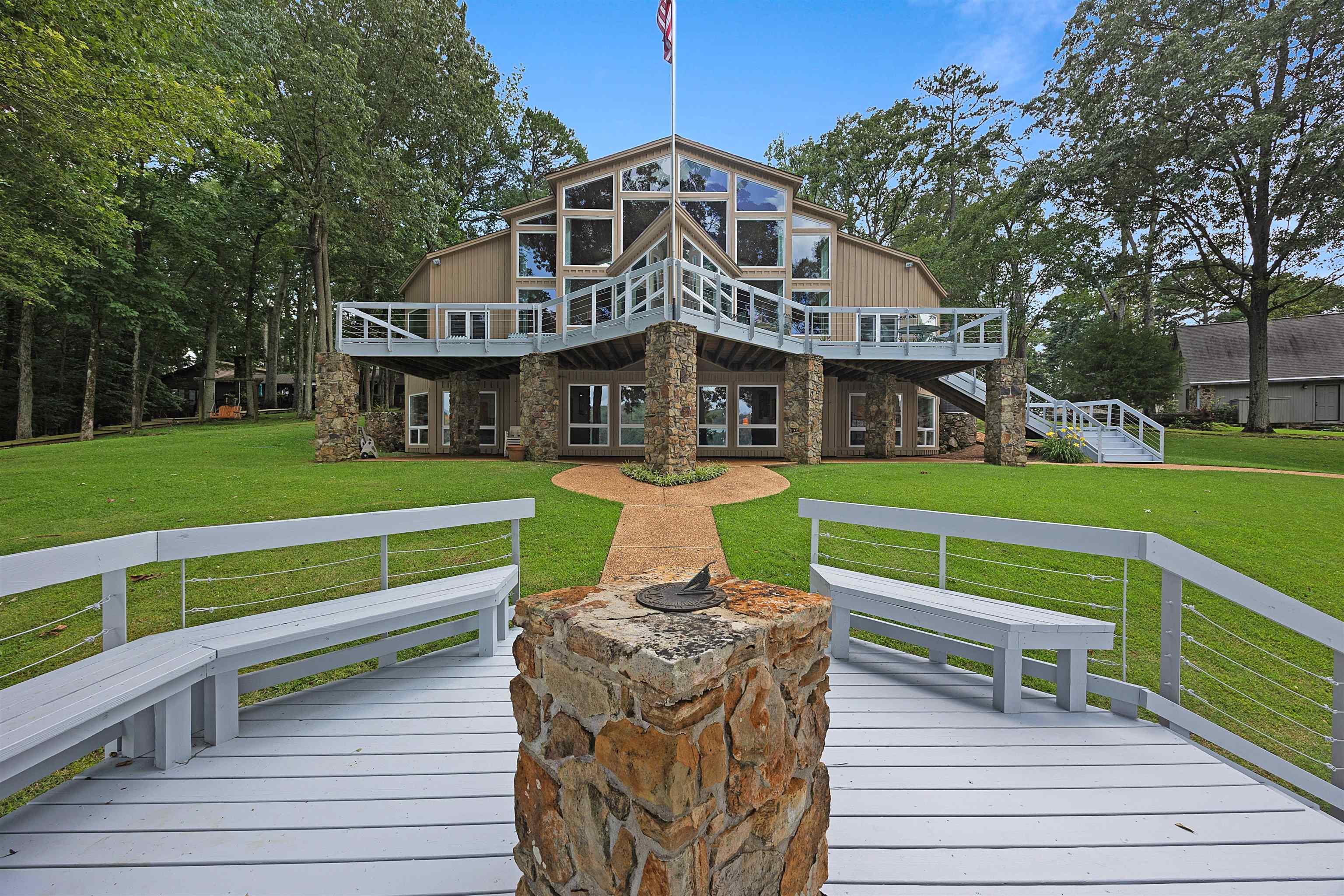 Image 4: Back of house featuring a wooden deck and a yard