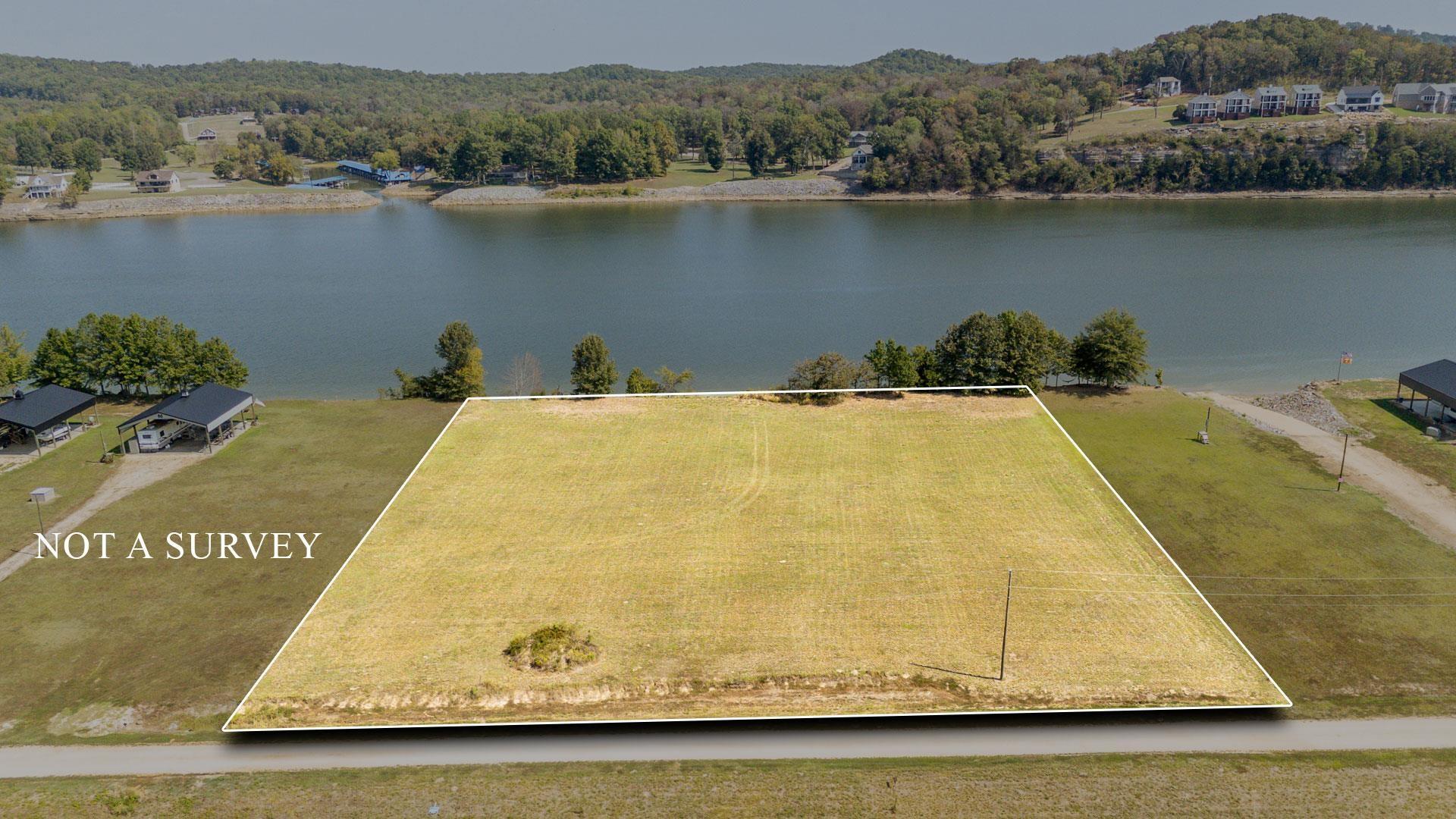 Image 1: View of property location featuring a large body of water and property boundaries highlighted