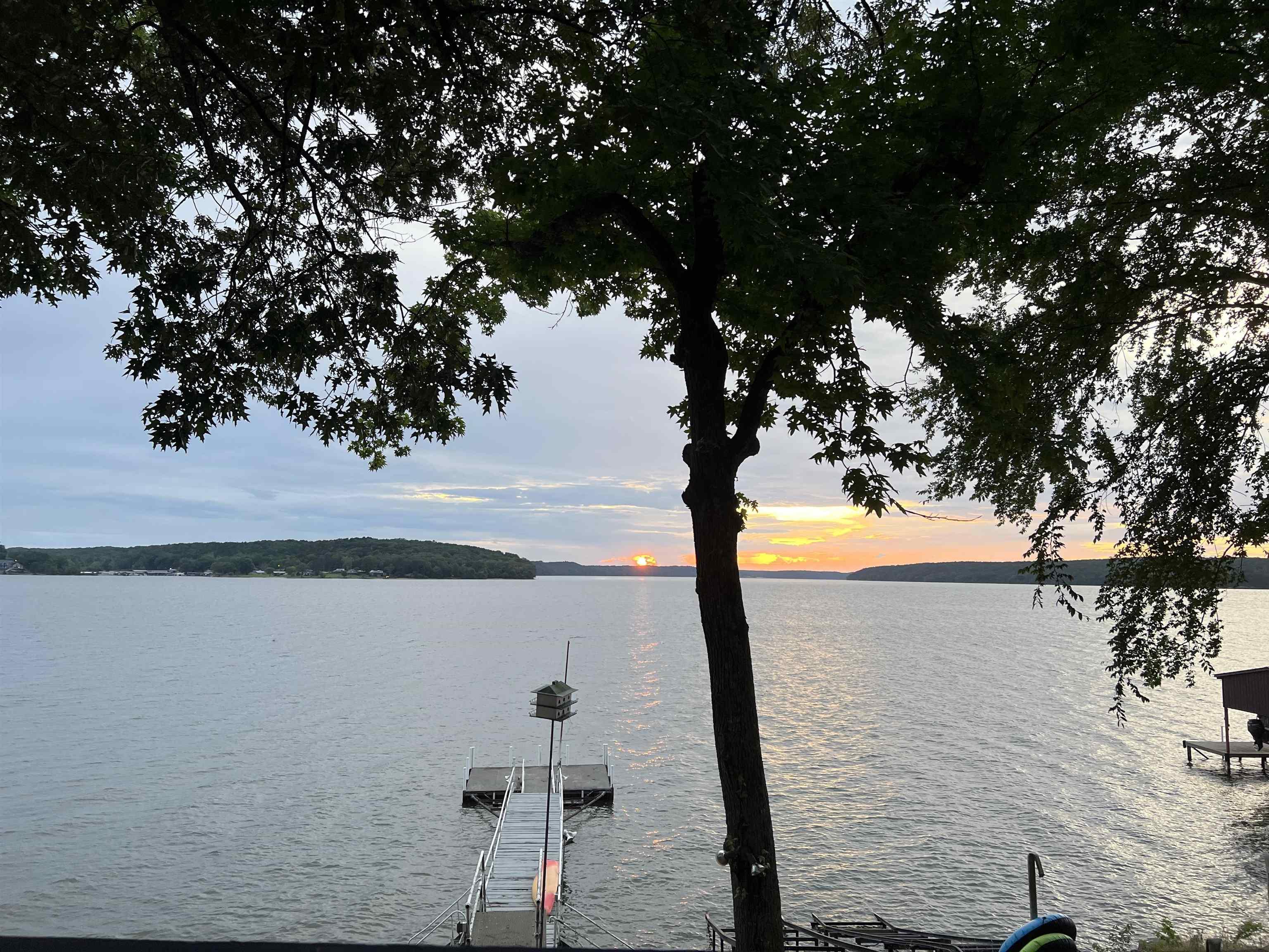 Image 1: Water view featuring a dock