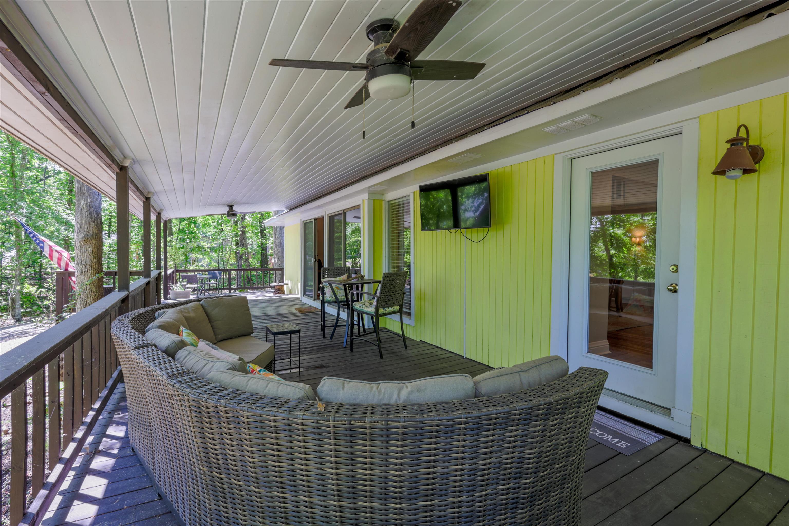 Image 3: Expansive covered deck featuring a dark wood-finish floor and white paneled ceiling