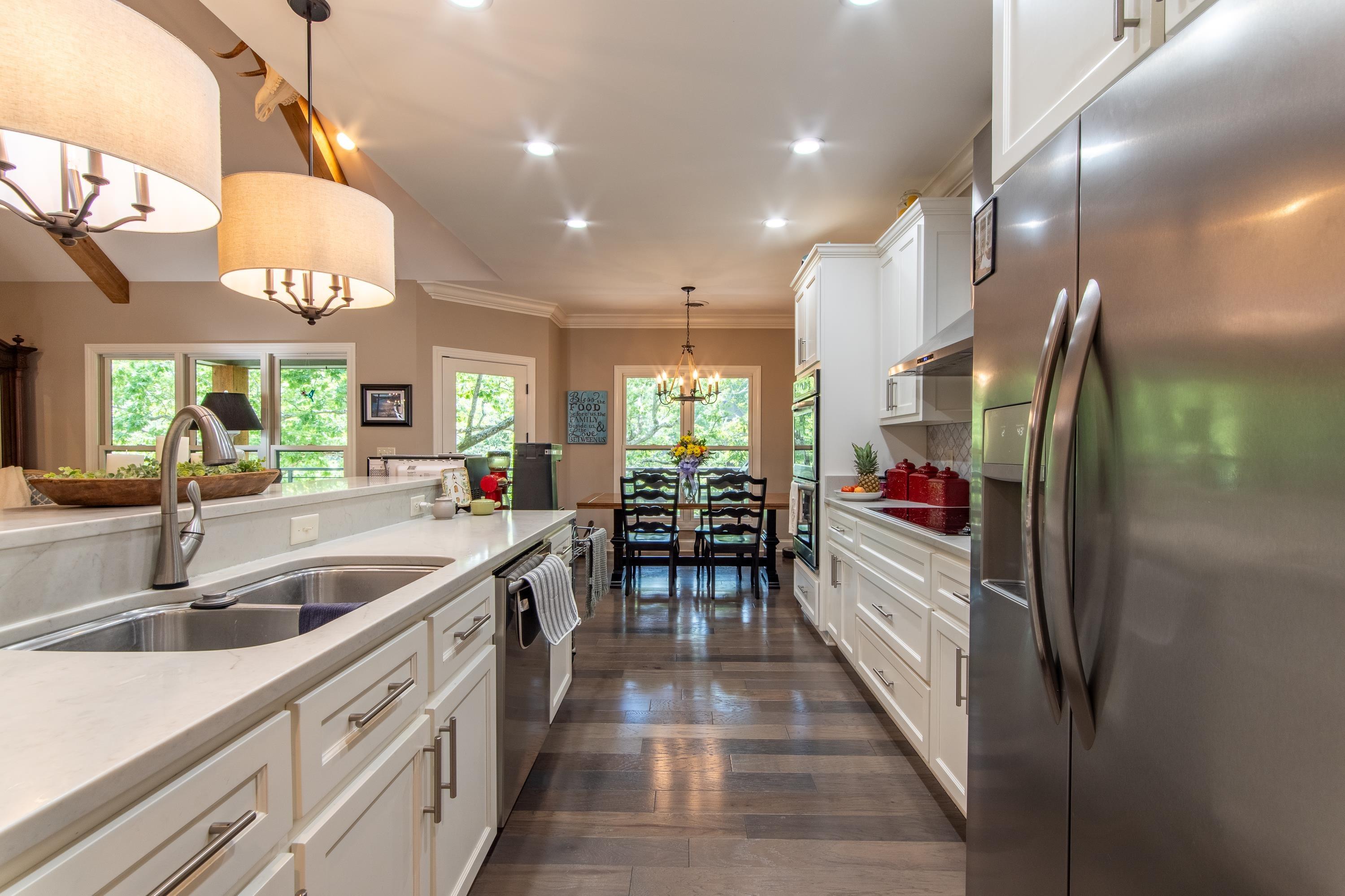 Image 4: Kitchen with plenty of natural light, sink, appliances with stainless steel finishes, and dark wood-type flooring