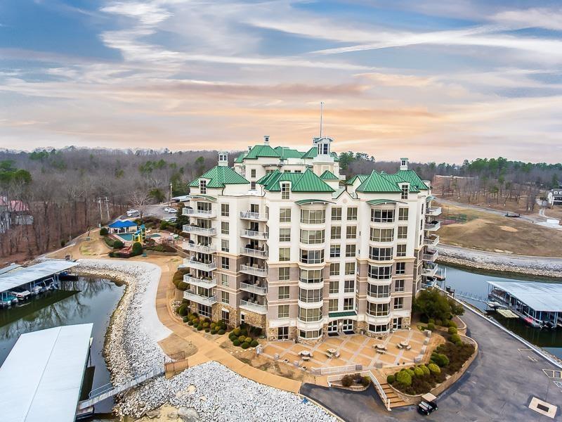 Image 1: Property at dusk featuring a water view and a view of apartment building / complex