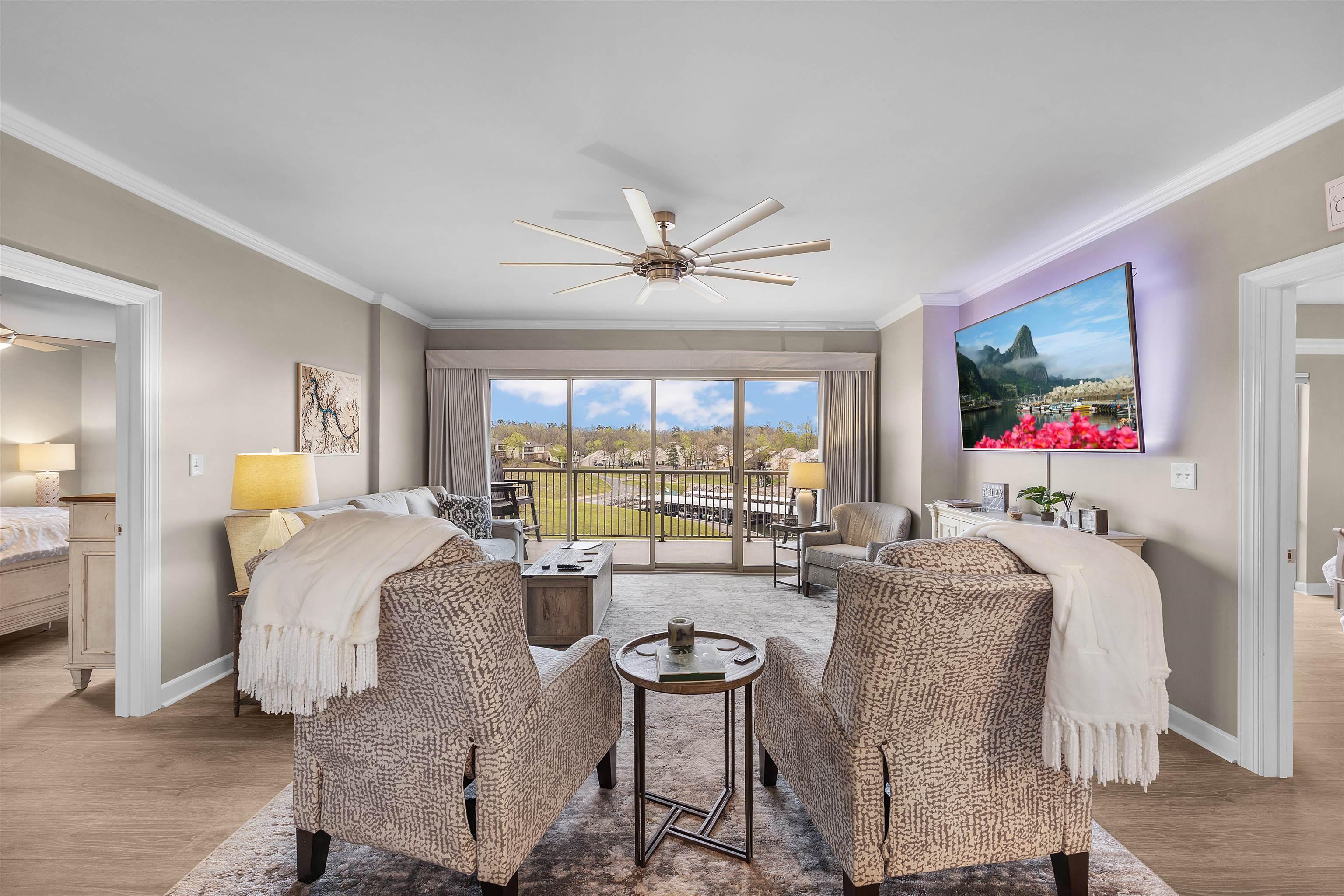 Image 2: Living room featuring ceiling fan, ornamental molding, and light wood-style flooring