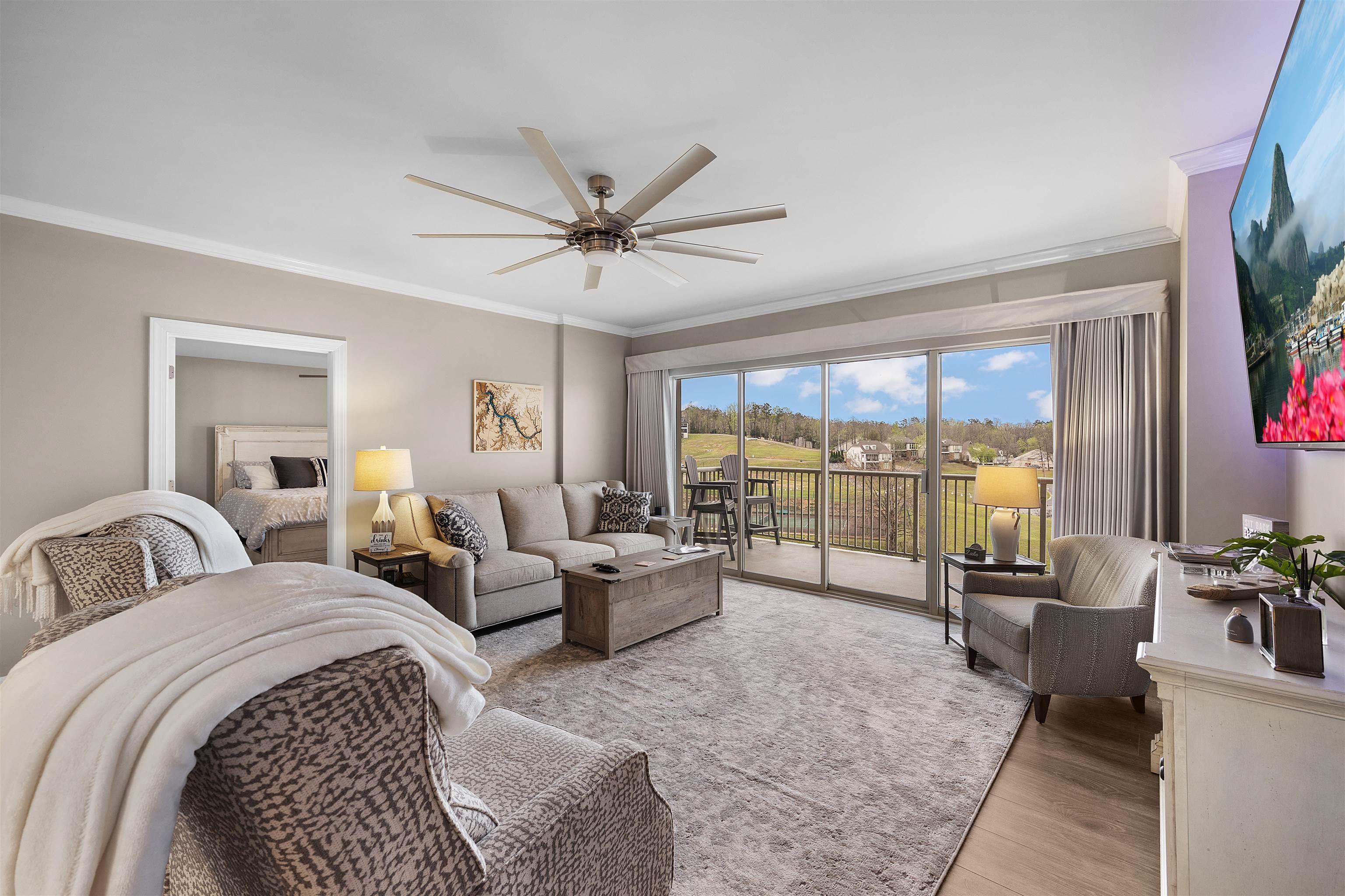 Image 3: Living area featuring crown molding, ceiling fan, and light wood-type flooring