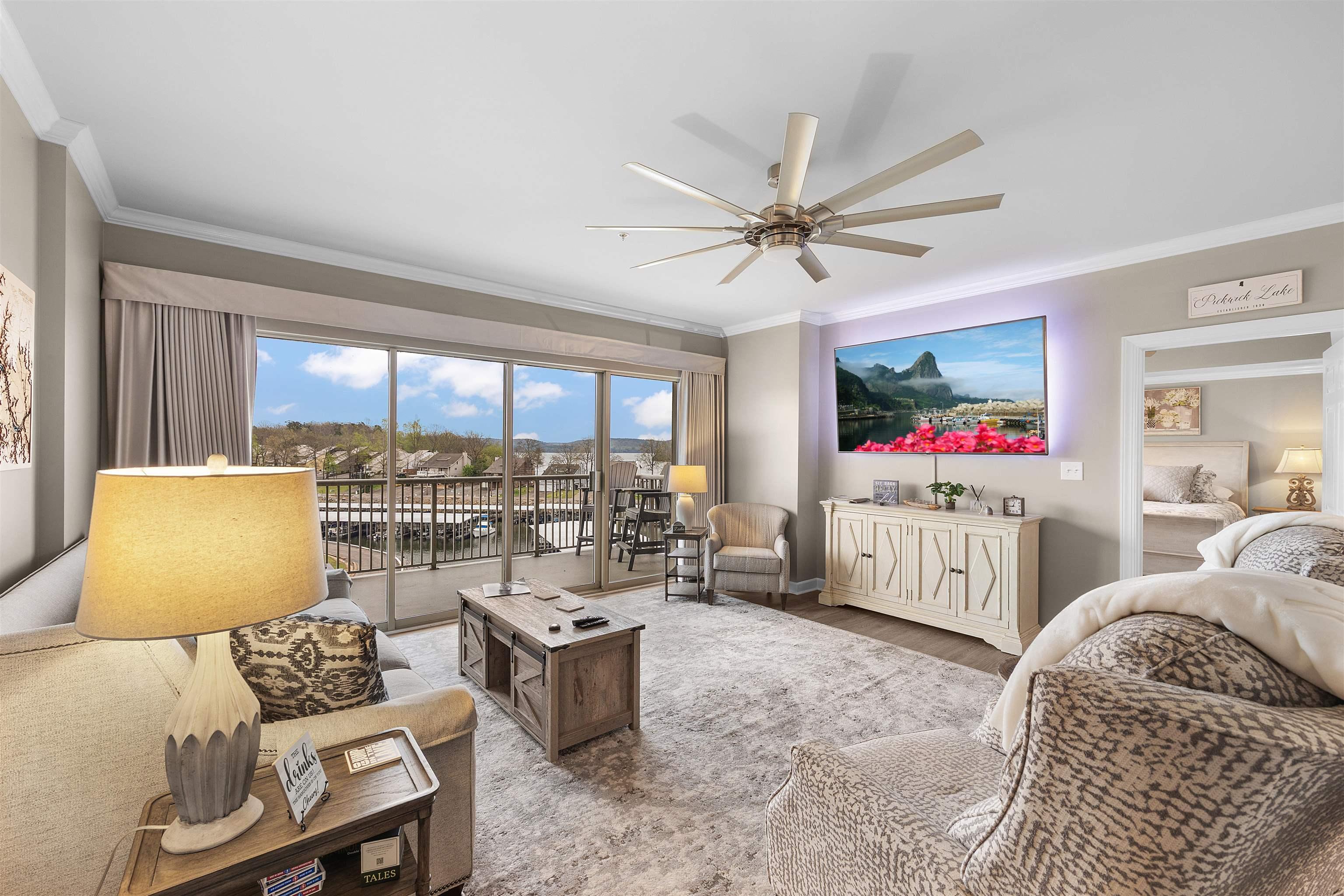 Image 4: Living room featuring a ceiling fan, crown molding, and wood finished floors