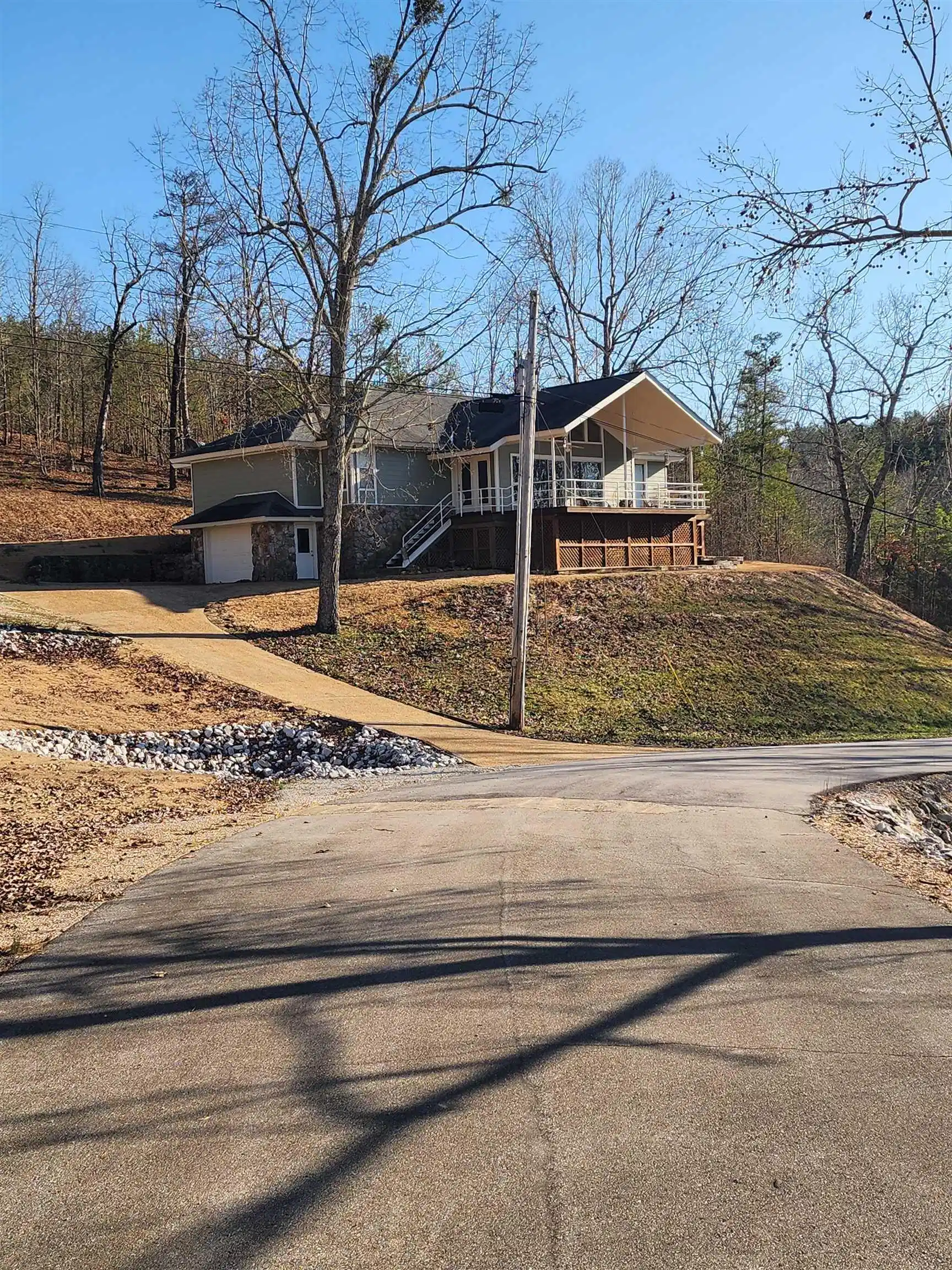 Image 1: Elevated property featuring a stone and siding exterior