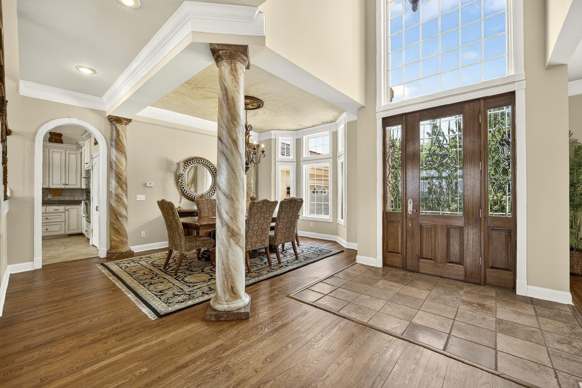 Image 2: Grand entryway featuring a double door with leaded glass sidelights and a transom window