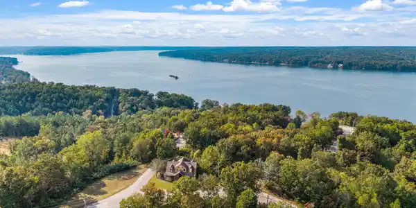 Image 3: Bird's eye view of a heavily wooded area and a large body of water
