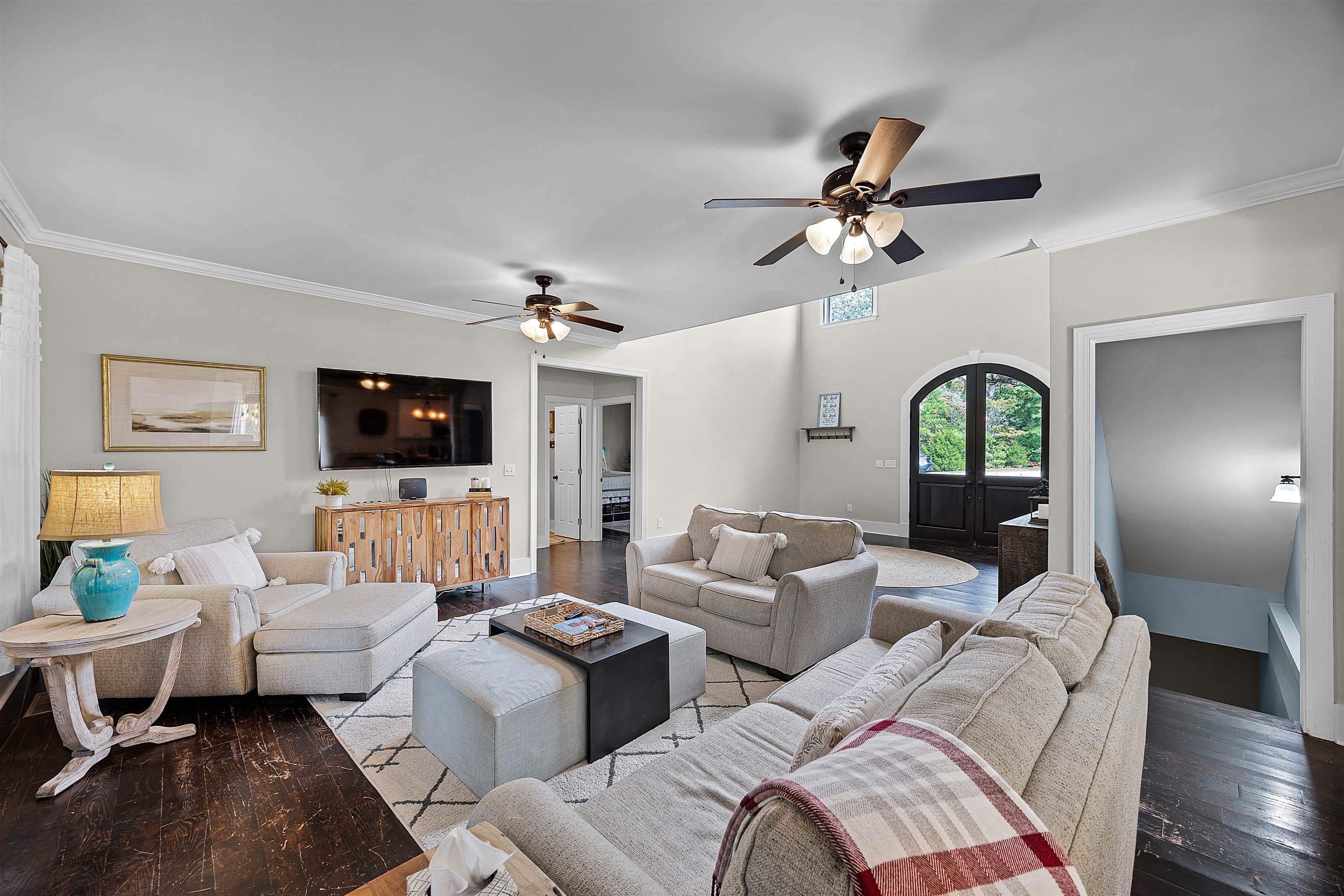 Image 4: Living room featuring ornamental molding, french doors, wood finished floors, and a ceiling fan