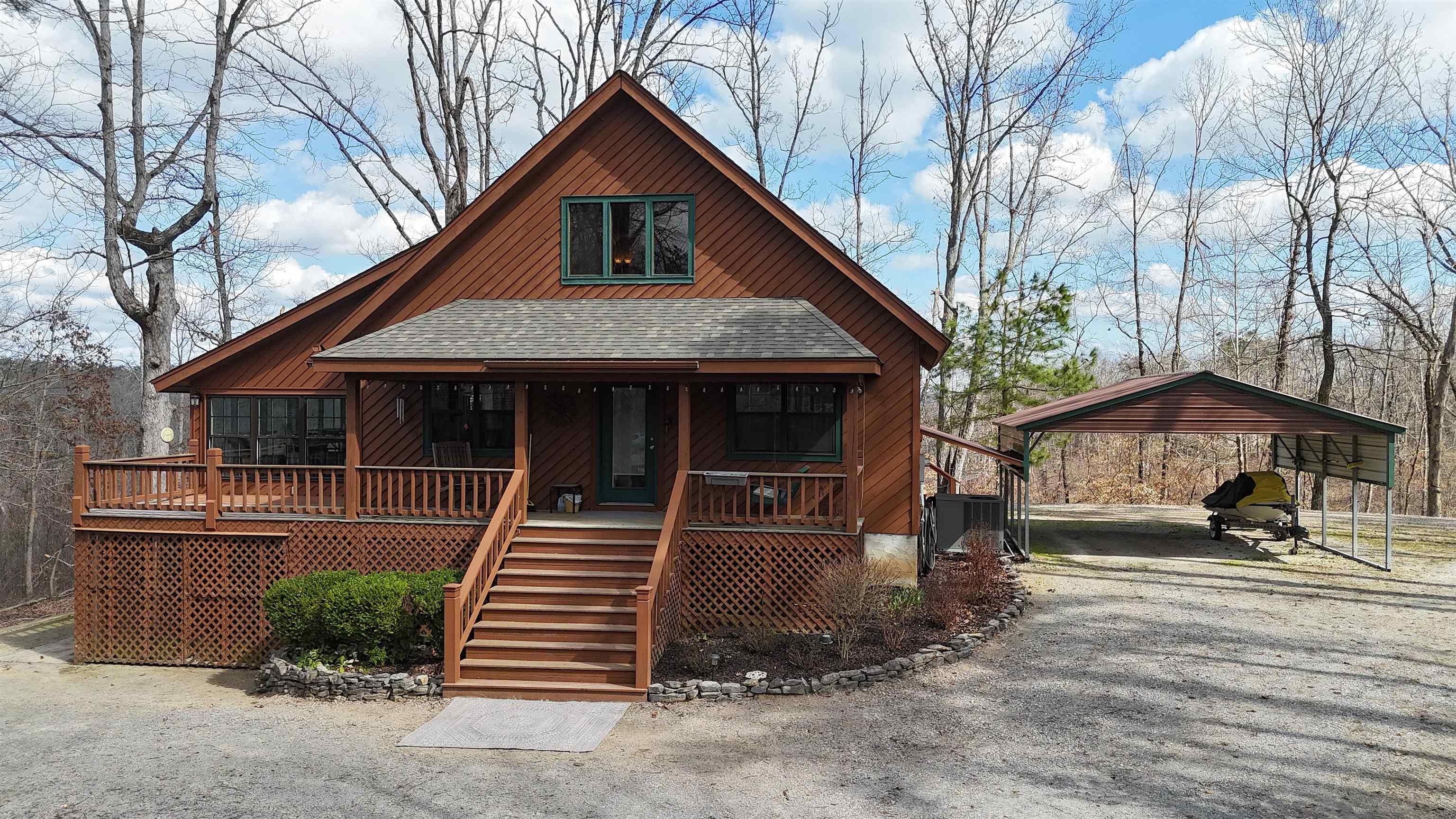Image 1: Nestled in the woods in a gated neighborhood...