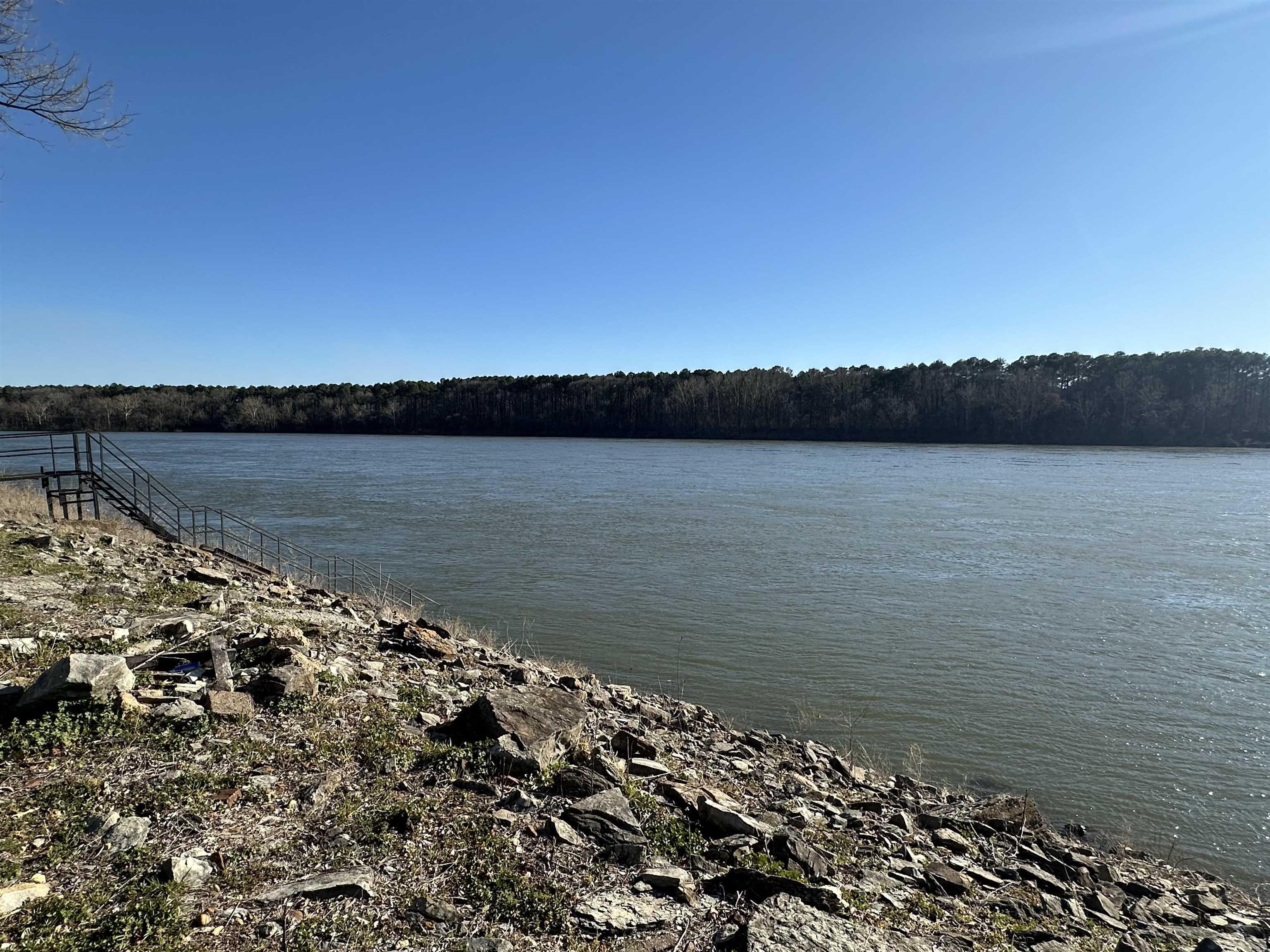 Image 1: Property view of water featuring a wooded view
