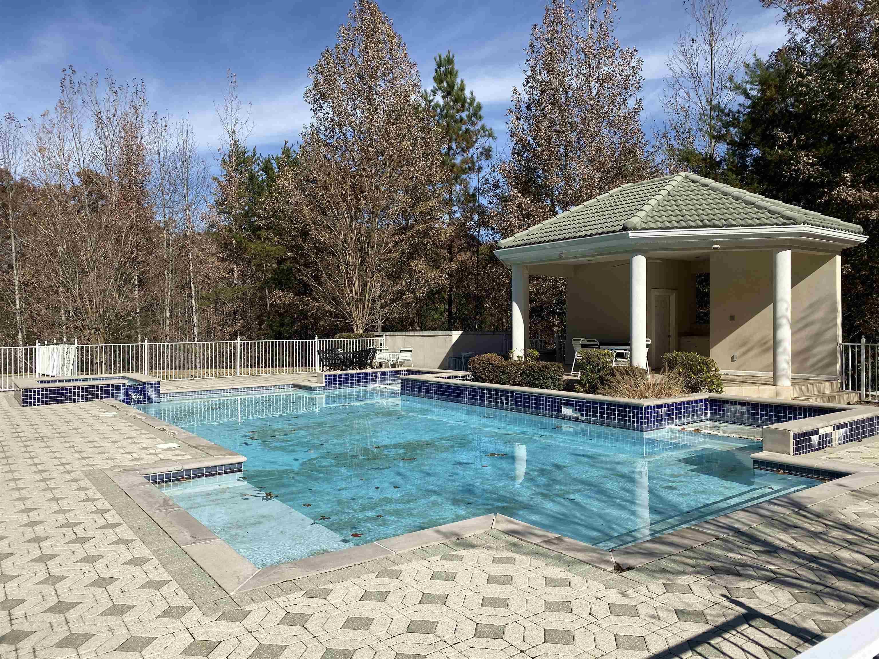 Image 3: View of pool with fence, a fenced in pool, and a patio