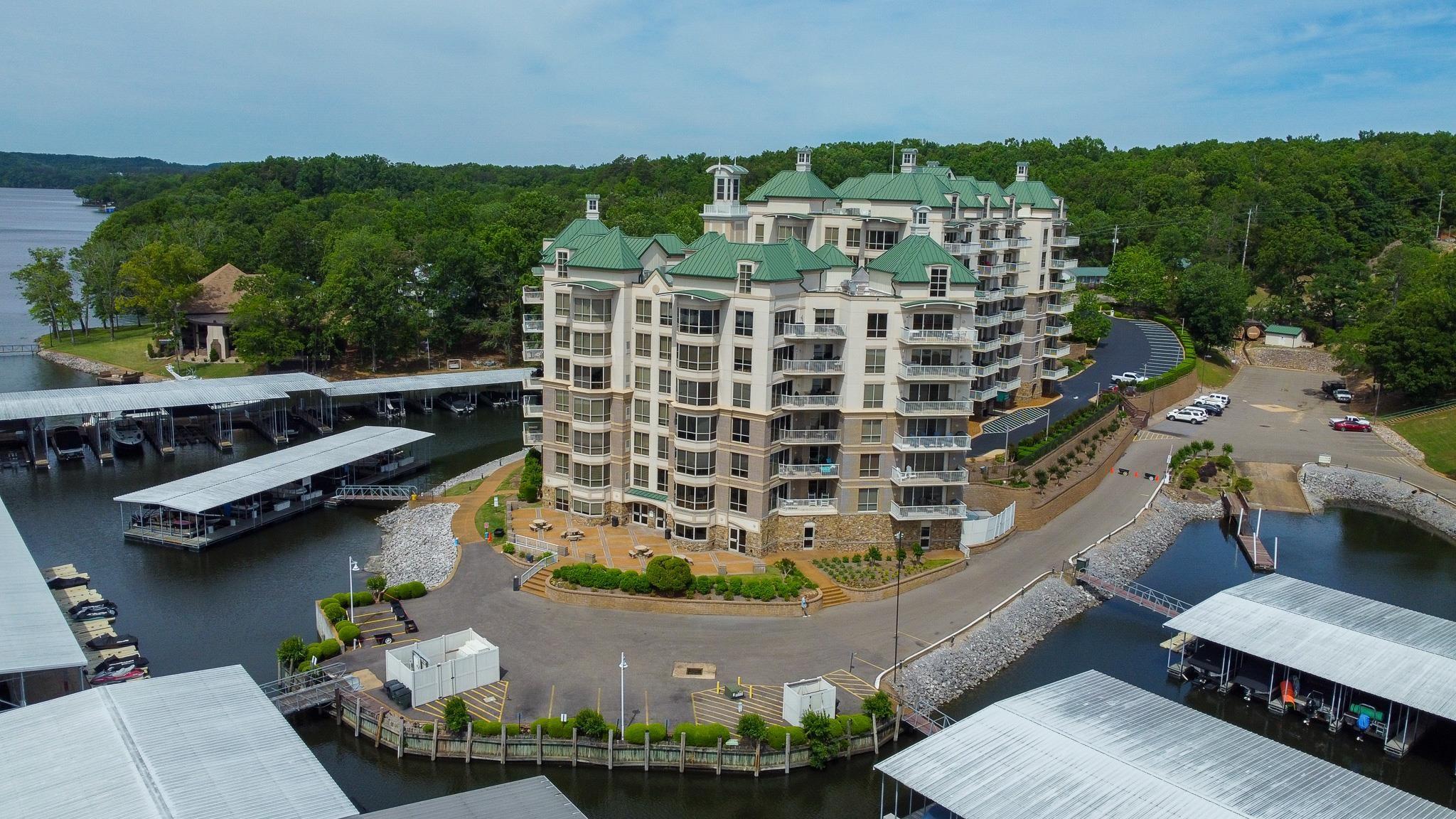 Image 1: Multi-story residential building featuring green hip roofs and multiple private balconies