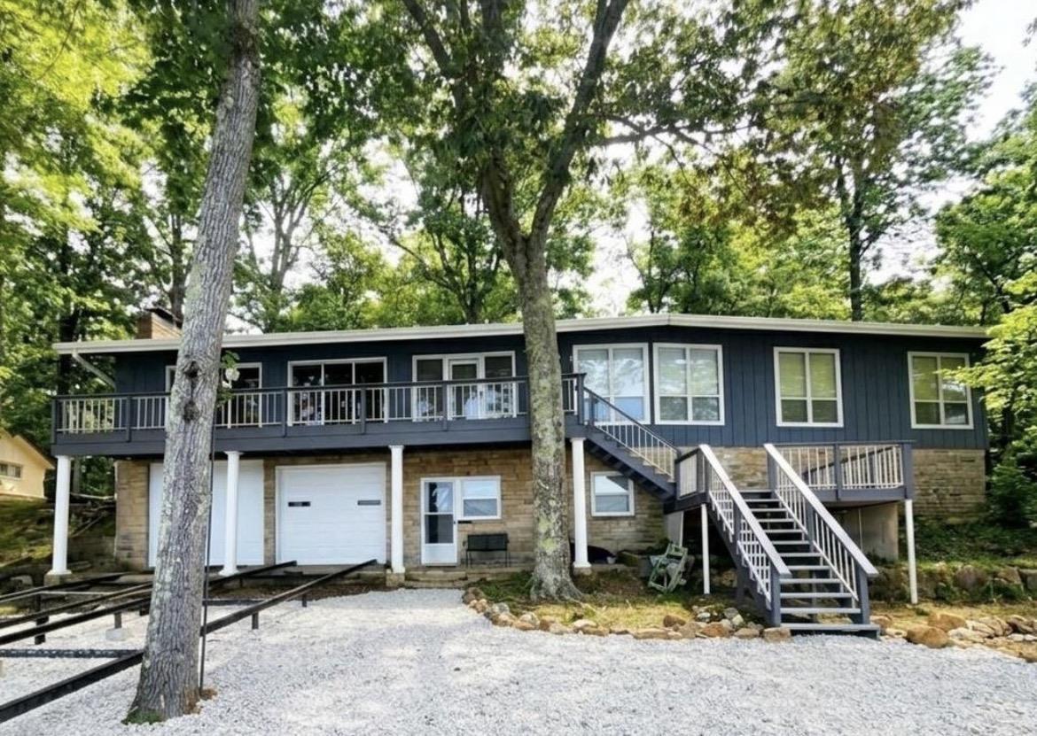 Image 3: Two-story residence featuring a stone and siding exterior