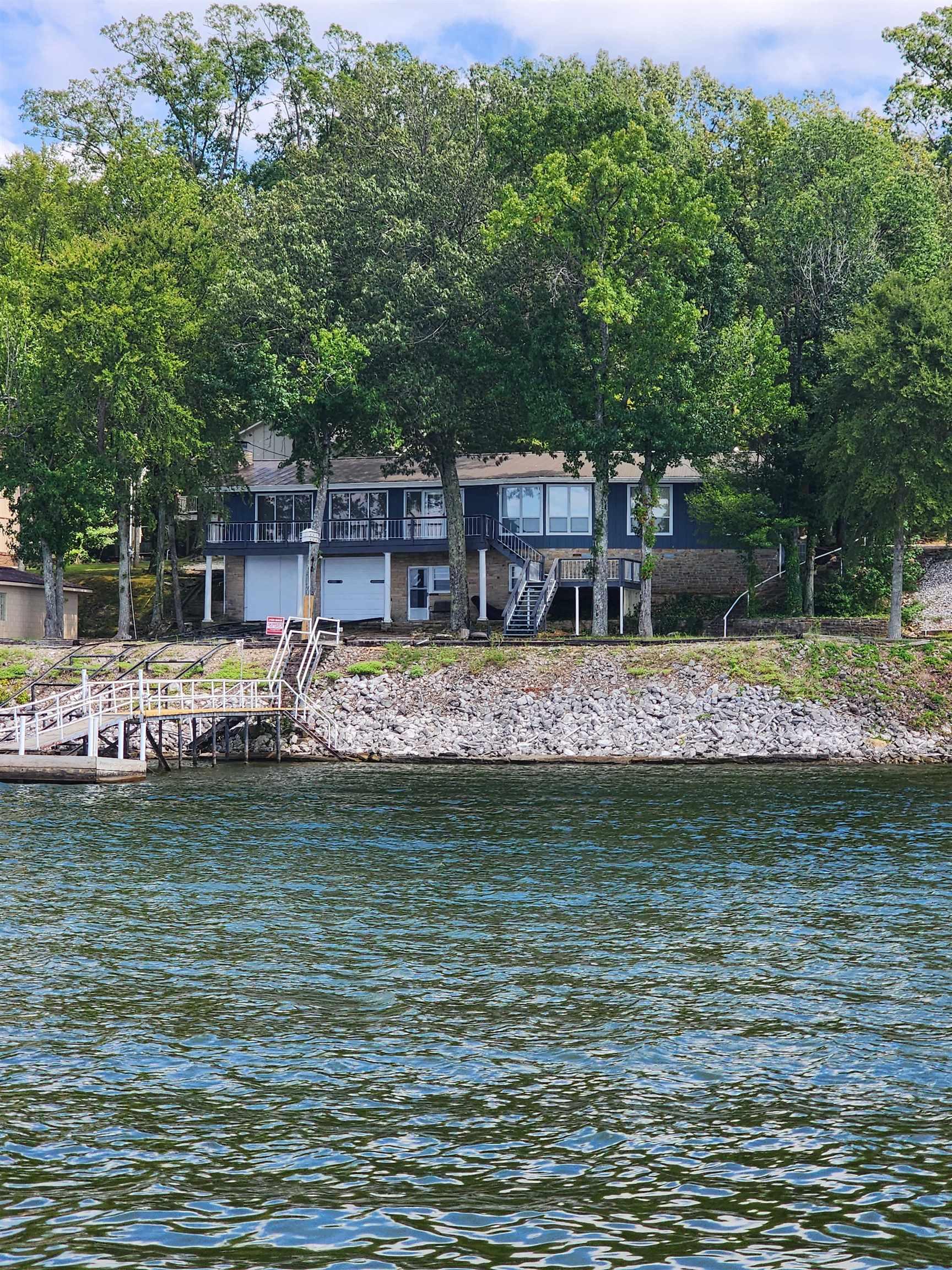 Image 2: Water view featuring stairway and a dock