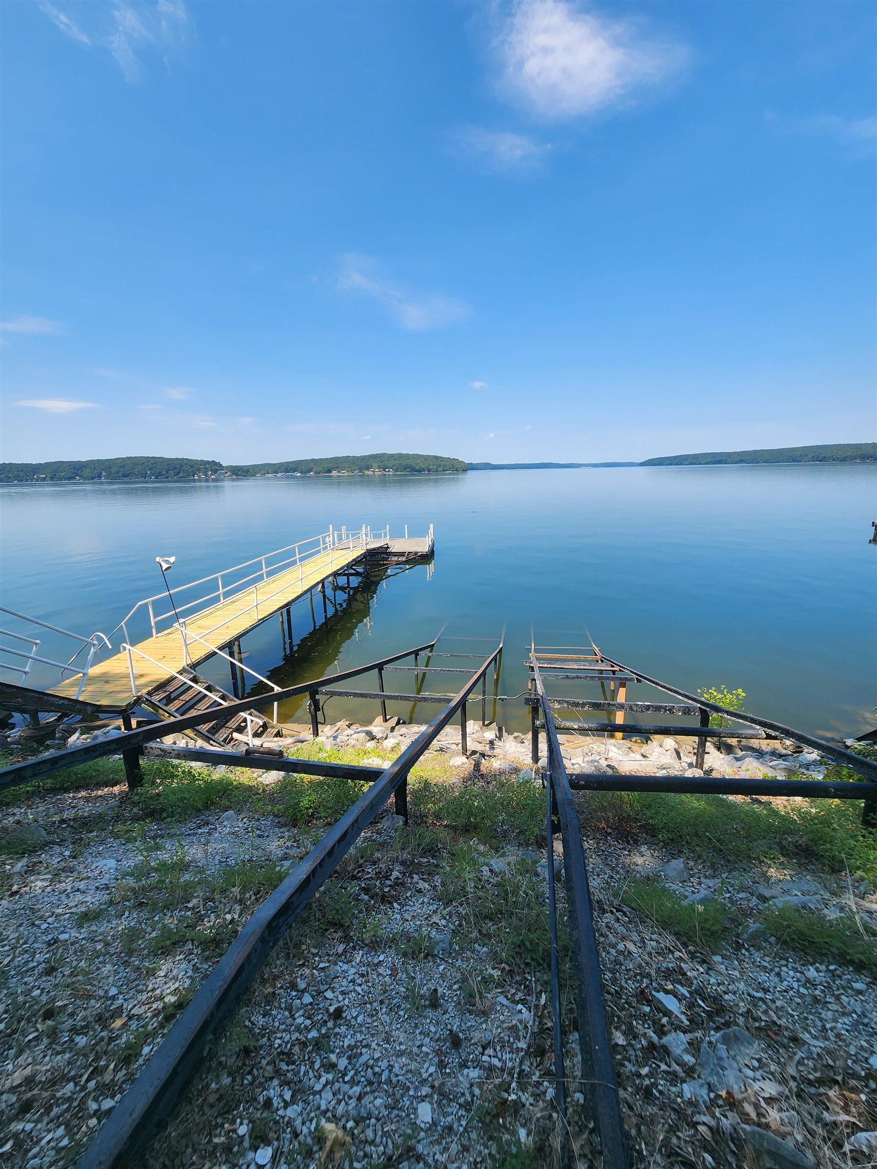 Image 3: Dock featuring a water view