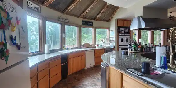 Image 3: Kitchen with white appliances, brick flooring, vaulted ceiling, recessed lighting, and plenty of natural light