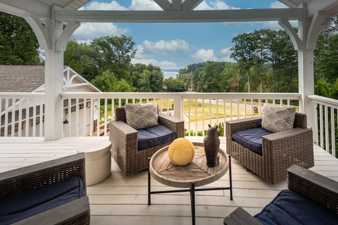 Image 1: Breathtaking views of the lake, trees, and sky from this home!
