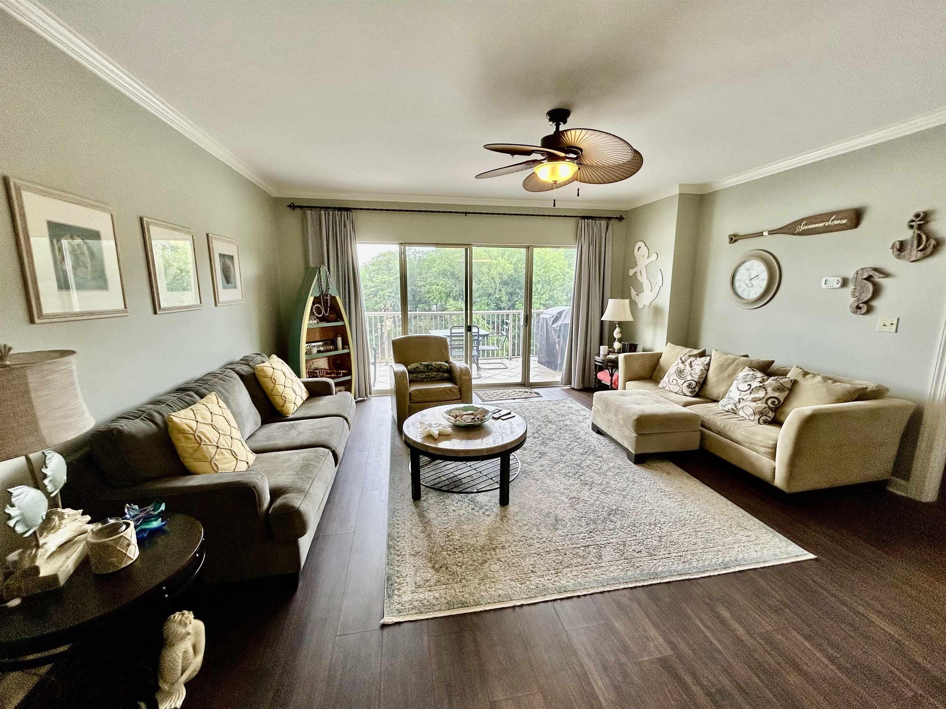 Image 3: Living area featuring ornamental molding, a ceiling fan, and dark wood finished floors