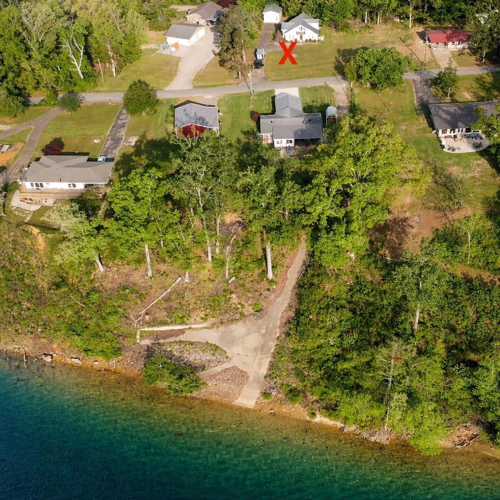 Image 3: Aerial view of a nearby body of water and a tree filled landscape
