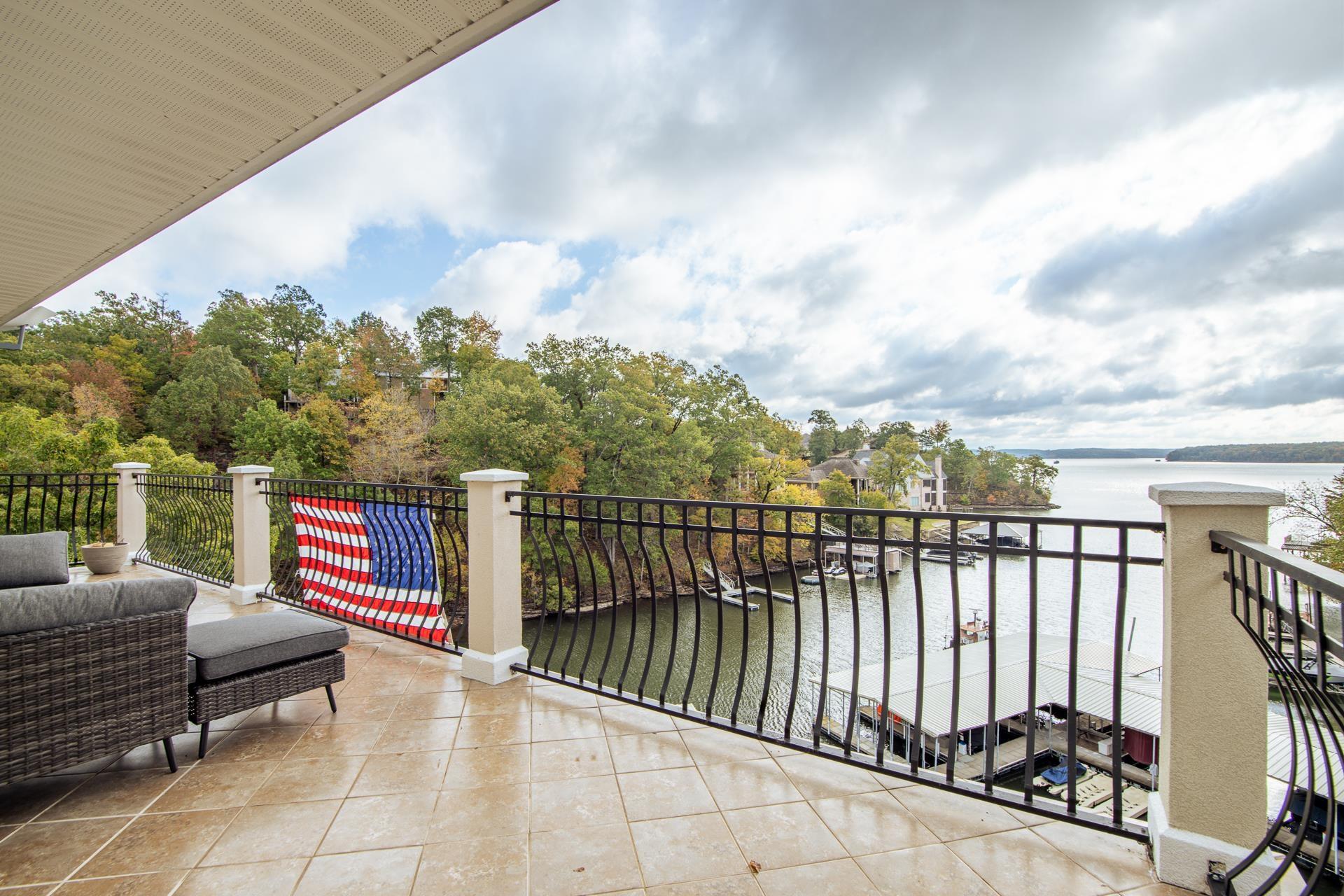 Image 4: Balcony featuring a water view