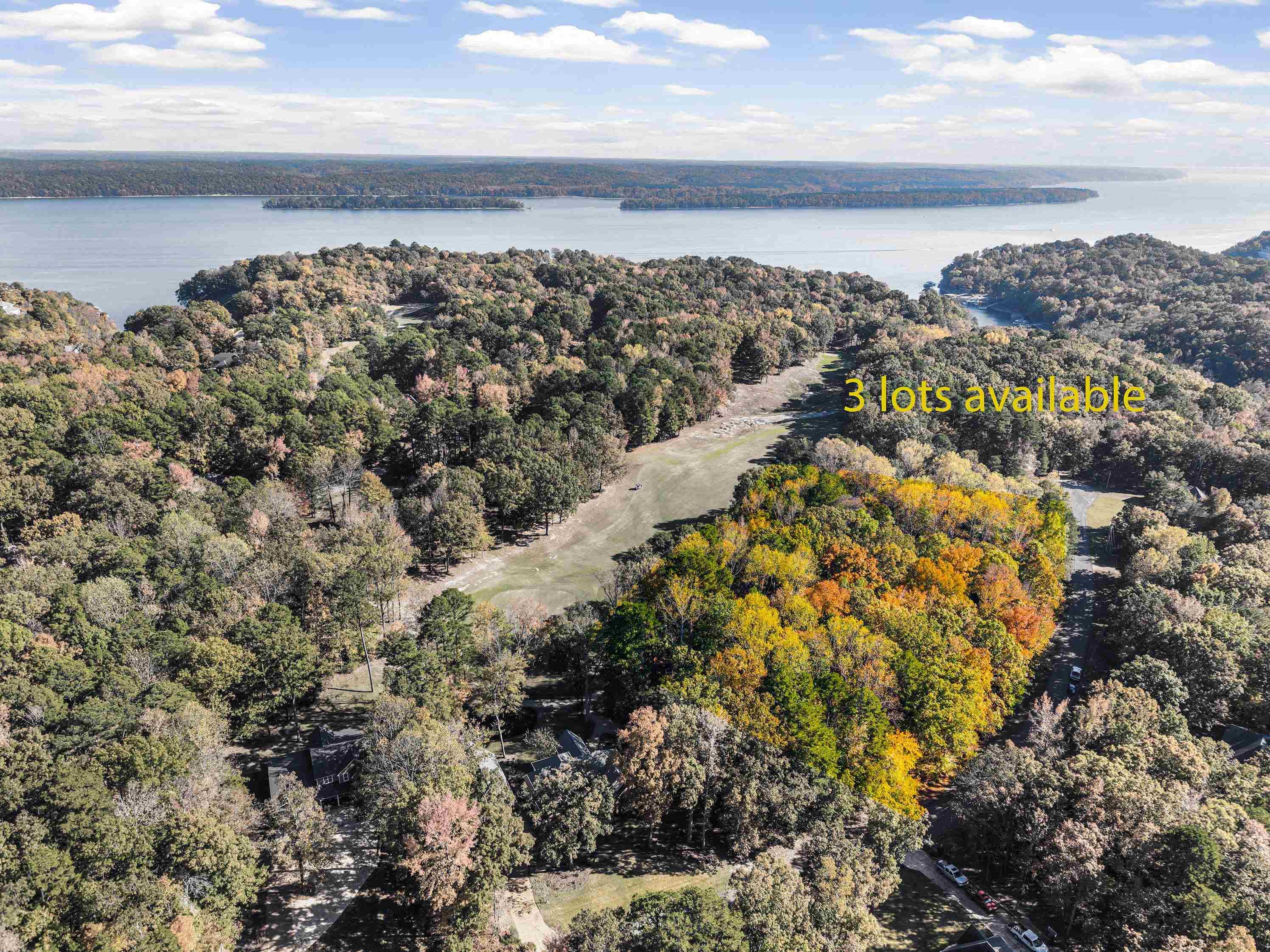 Image 1: Aerial view of property and surrounding area with a large body of water