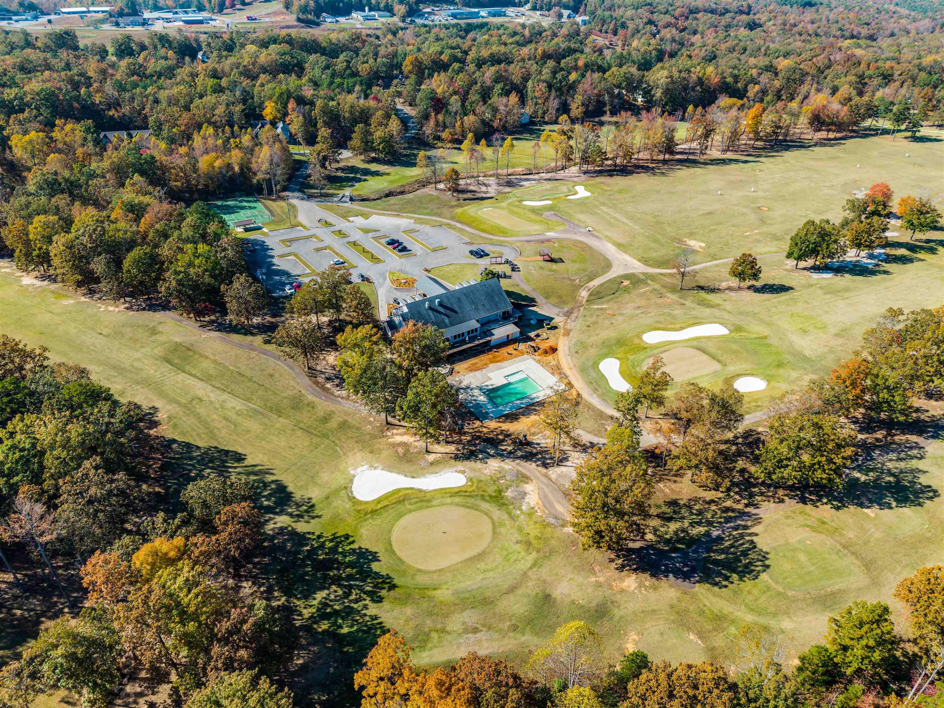 Image 4: Aerial overview of property's location with a golf course