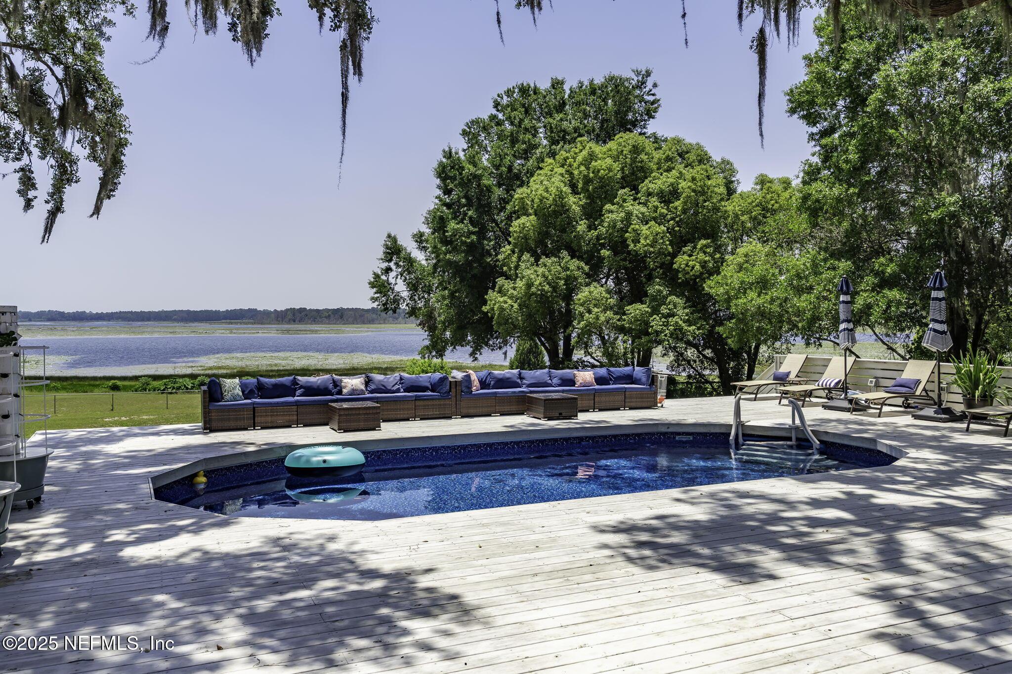 Image 3: SPACIOUS POOL AND DECK OVER LOOKING LAKE