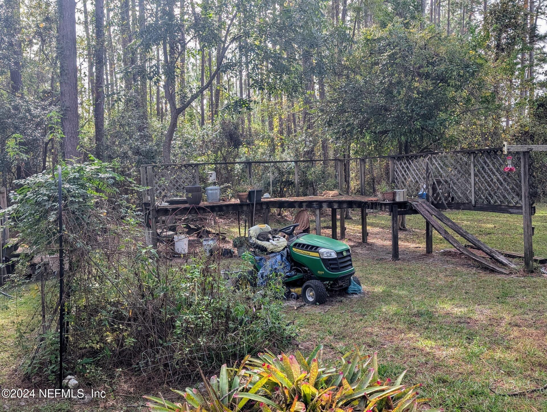 Image 3: Backyard Garden with Lawn Mower