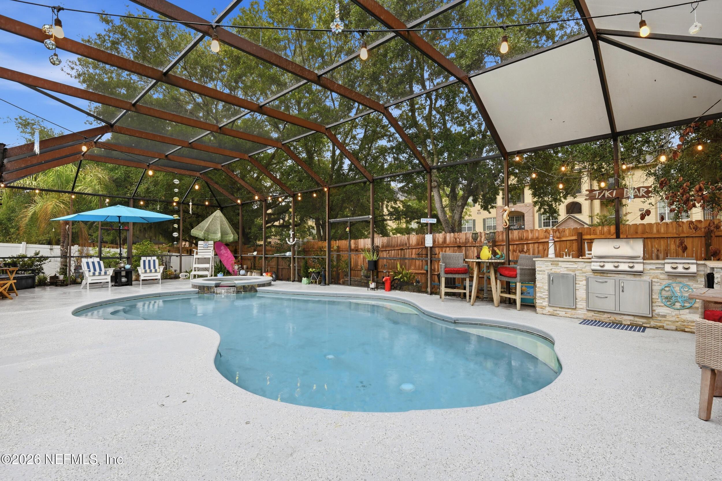 Image 4: enclosed pool and outdoor kitchen