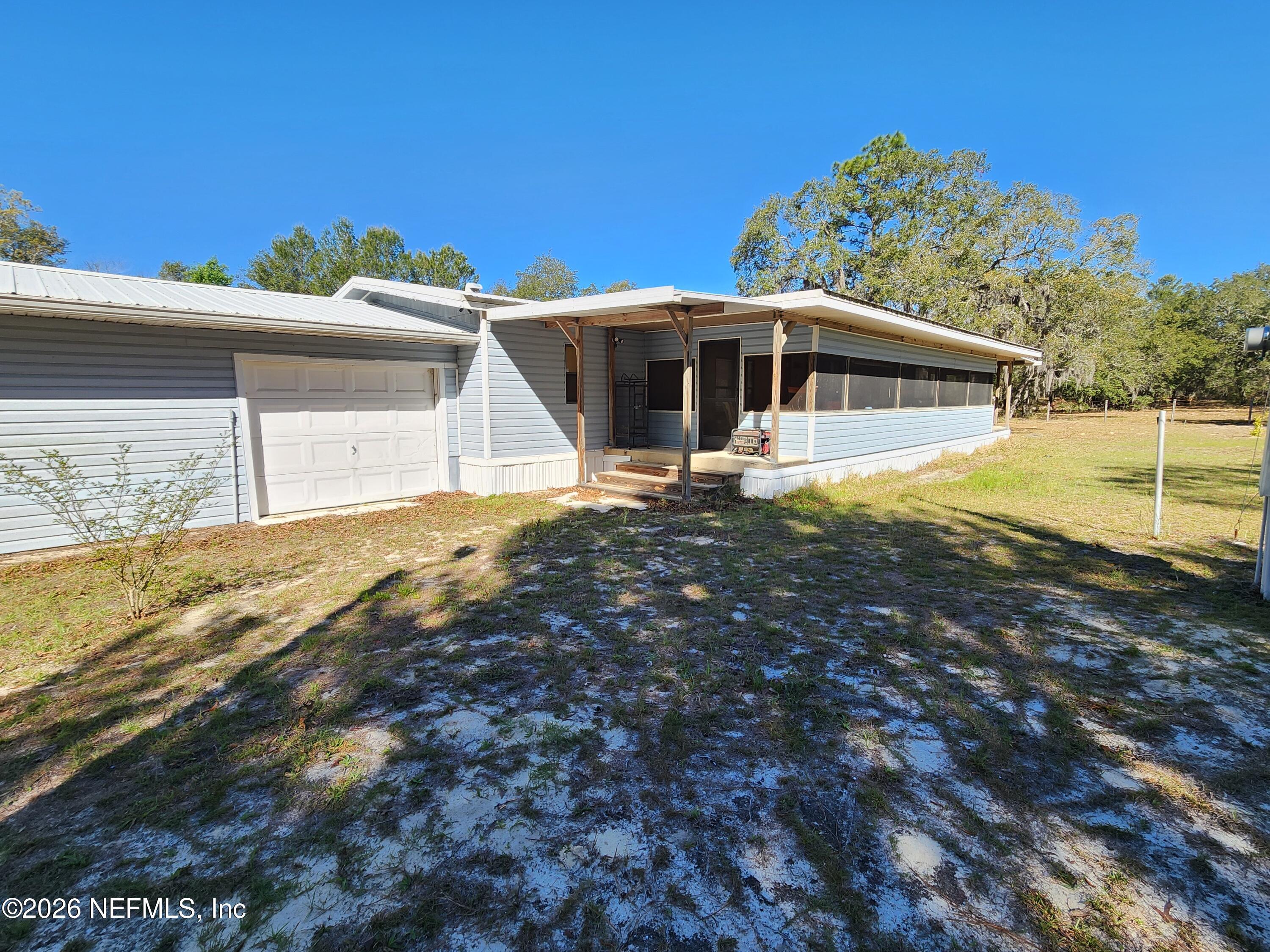 Image 4: Back Porch w/Garage Door