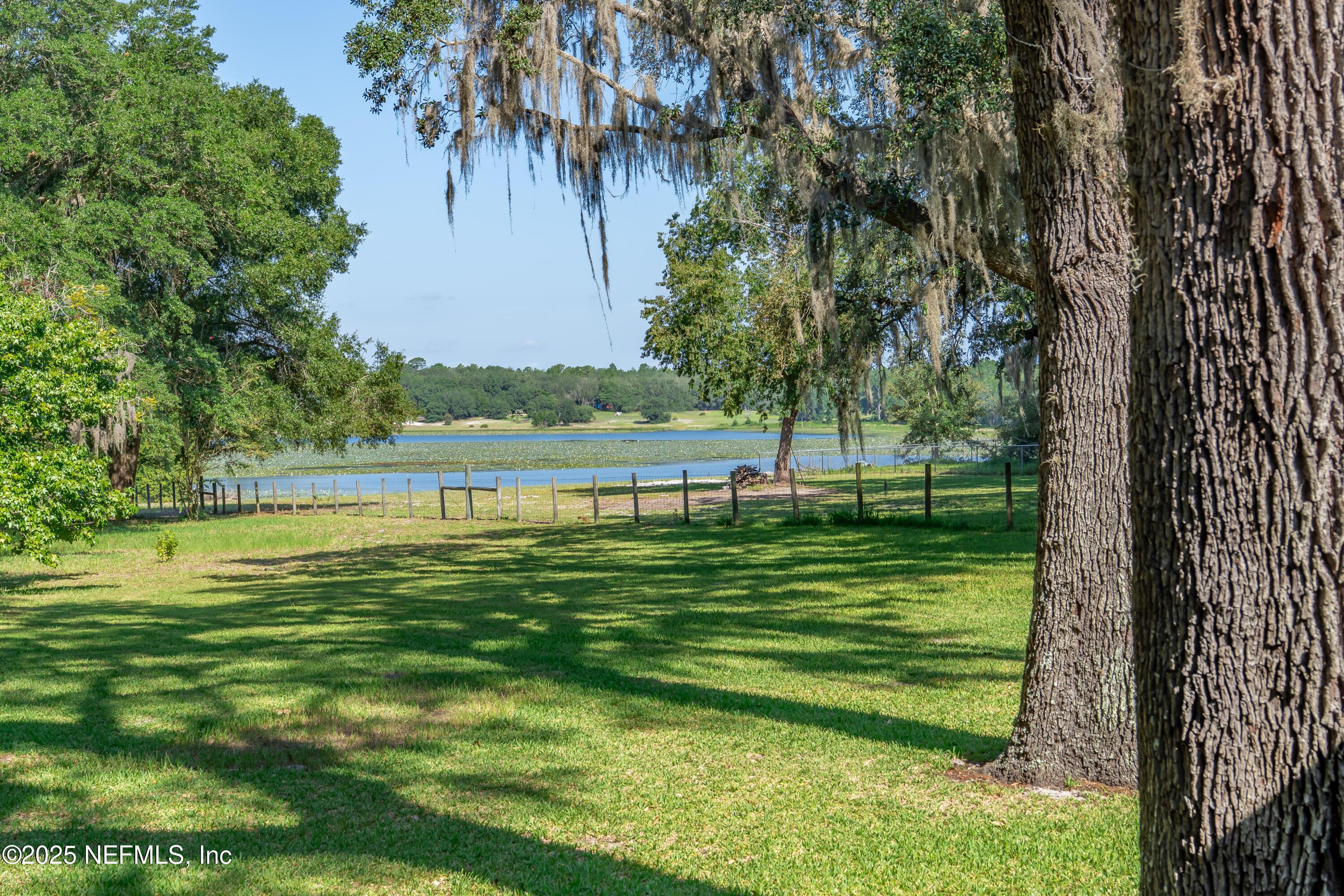 Image 1: VIEW OF LAKE AND YARD