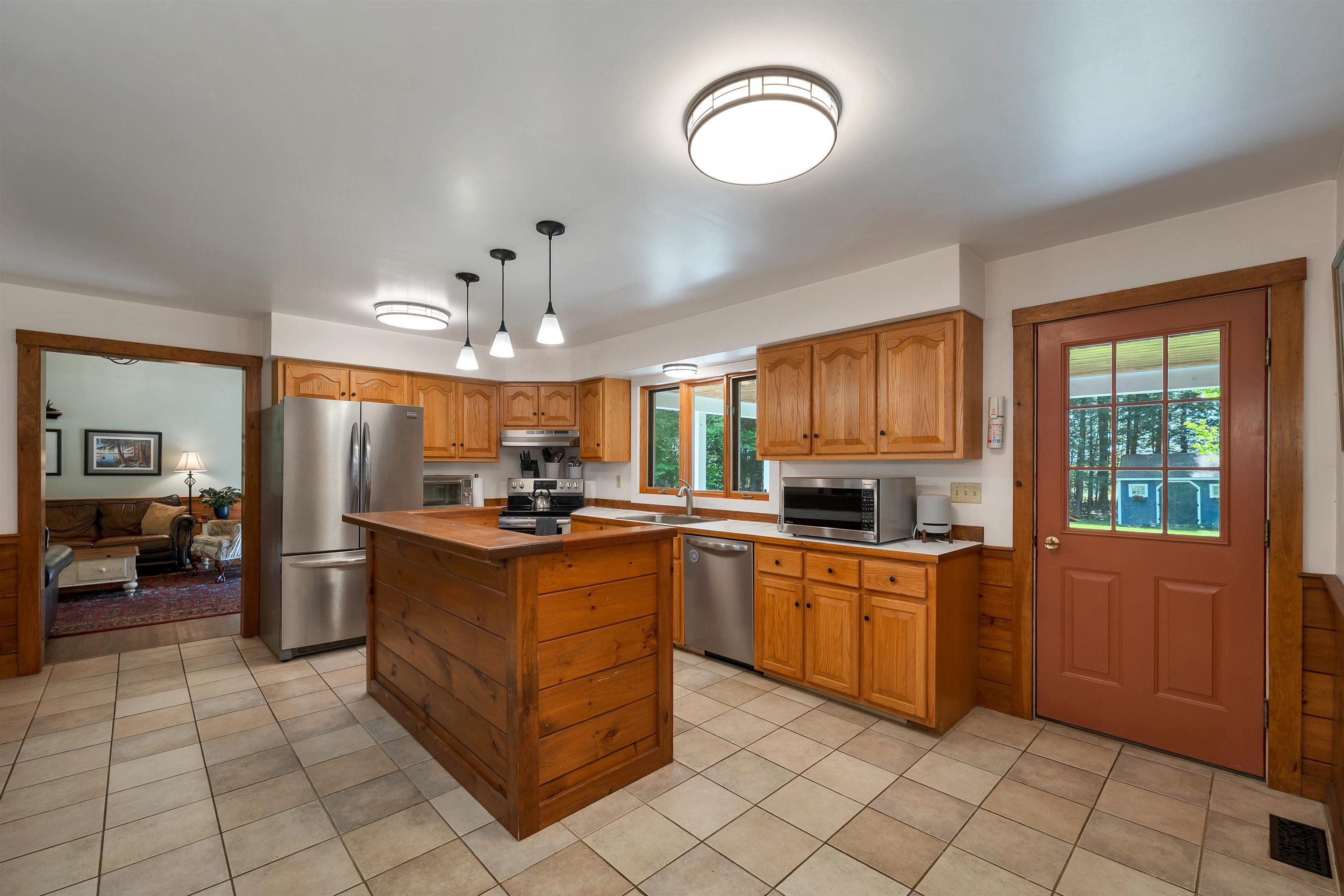 Image 4: A spacious kitchen with natural wood character and everyday 