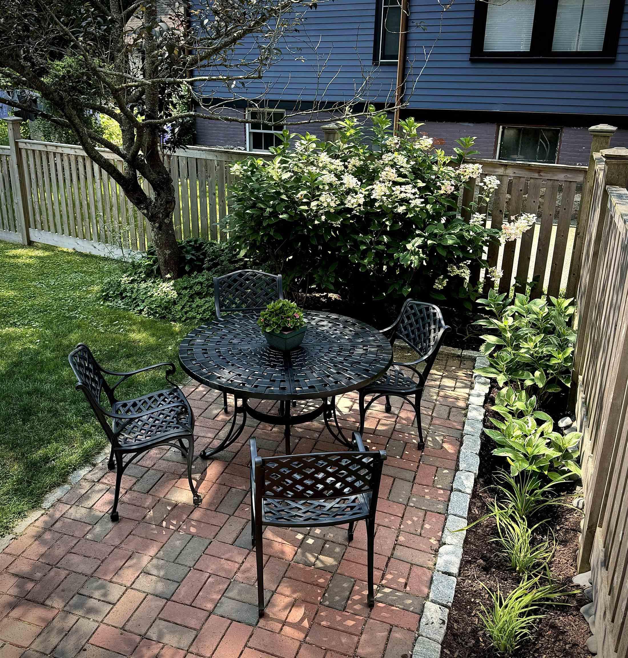 Image 3: Private fenced yard w/patio & pocket gardens Image 3: Private fenced yard w/patio & pocket gardens