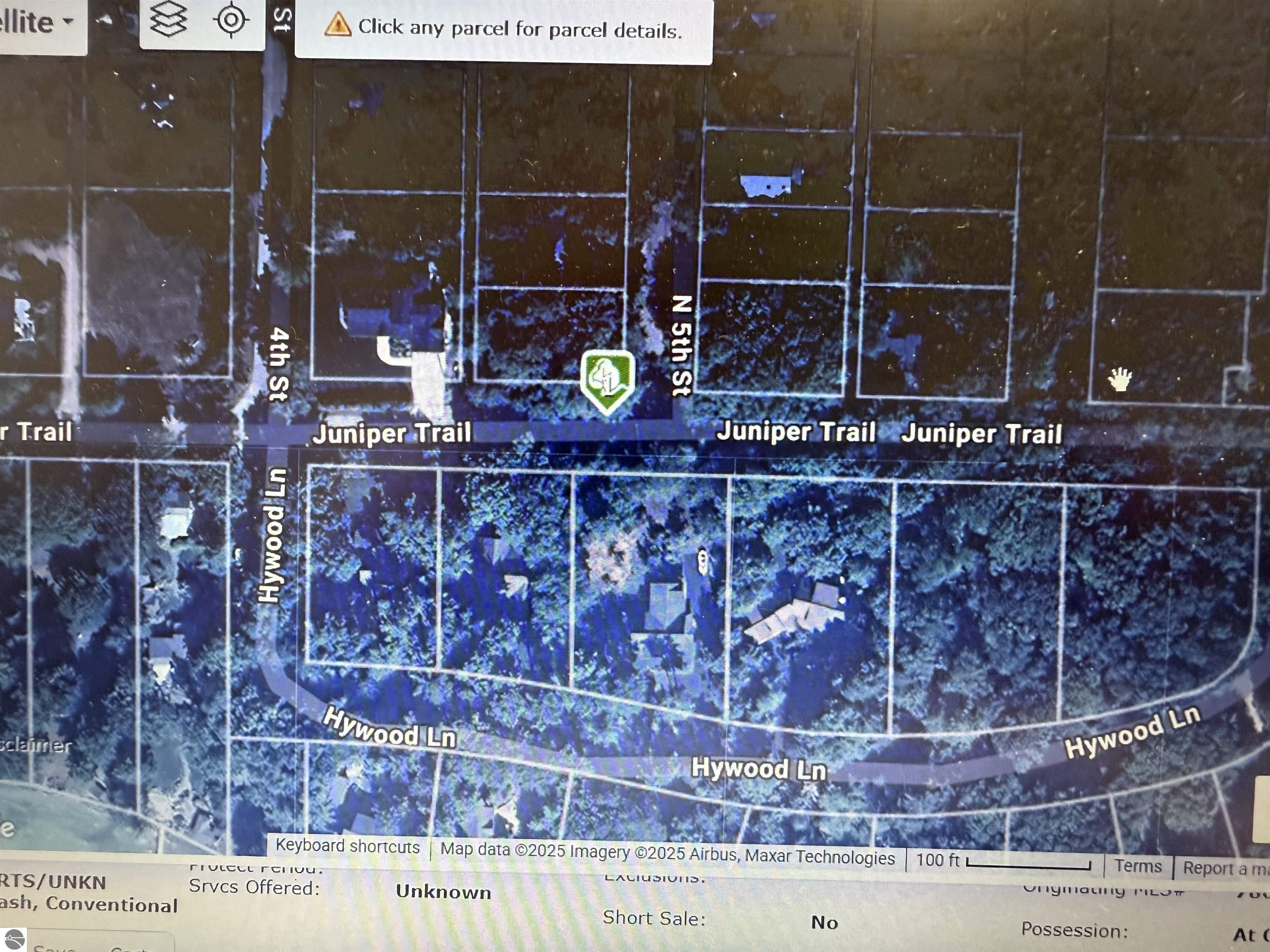Image 2: Aerial view of corner lot on northwest corner of Juniper Trail and 5th Streets.  Leland Township maintains beach access at the end of 4th street and Hywood.