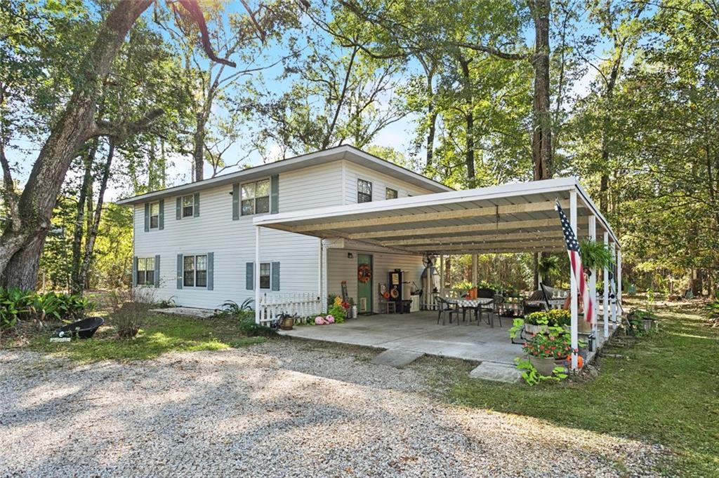 Image 1: Front with gorgeous trees surrounding